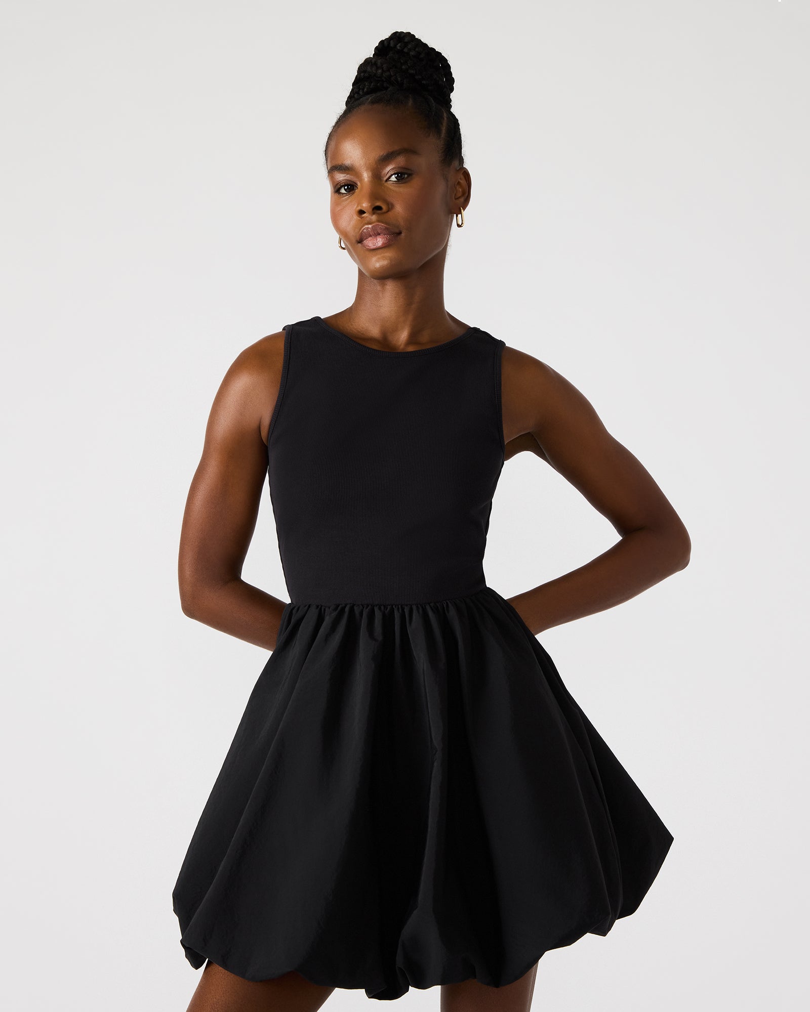 Model wearing a stylish black strapless mini dress suitable for evening events.