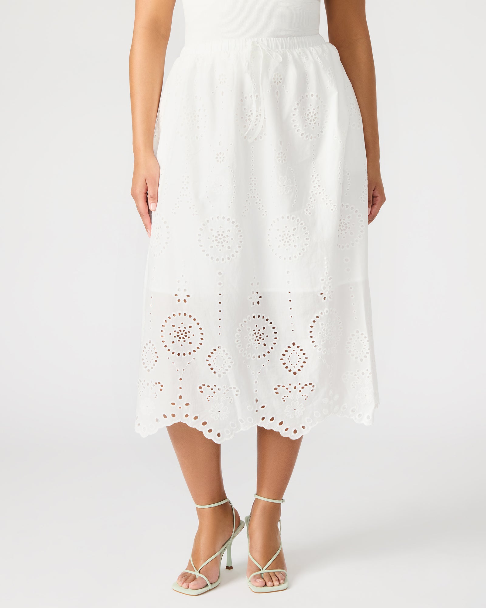 Outfit shot featuring floral midi skirt paired with neutral-toned accessories