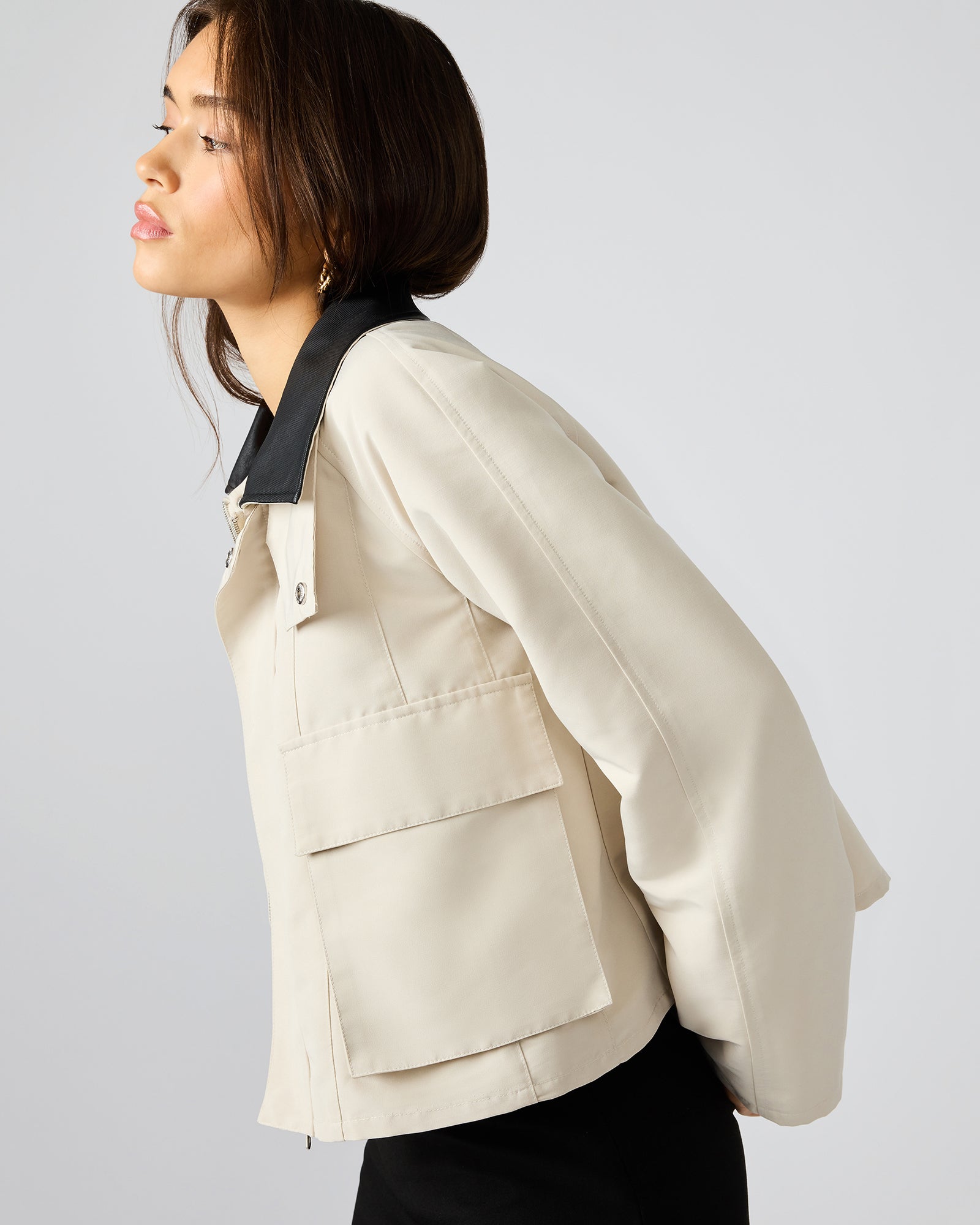 Woman pairing the oatmeal jacket with casual attire for a stylish daytime look