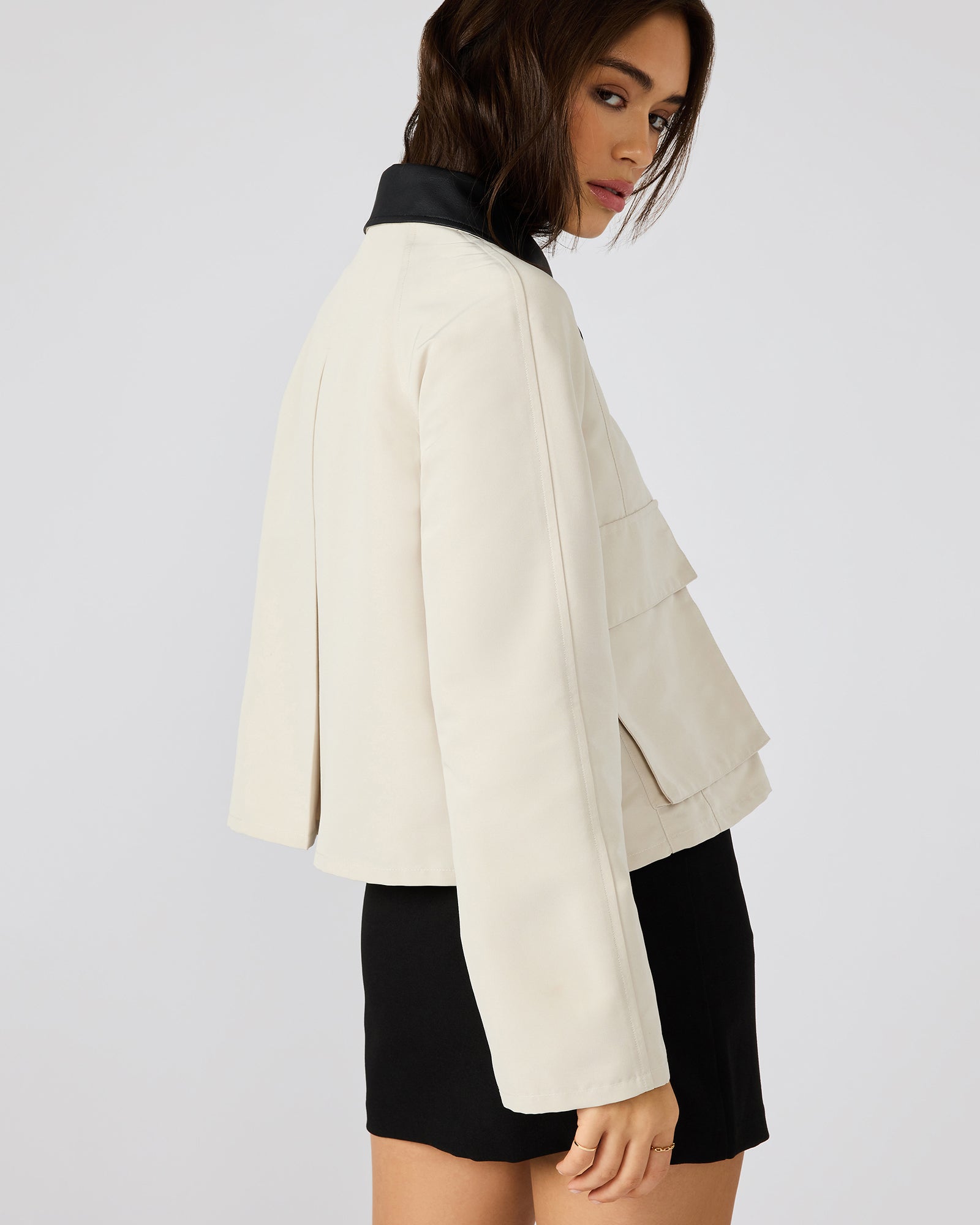 Model wearing the oatmeal button-up jacket with a polished look for casual outings