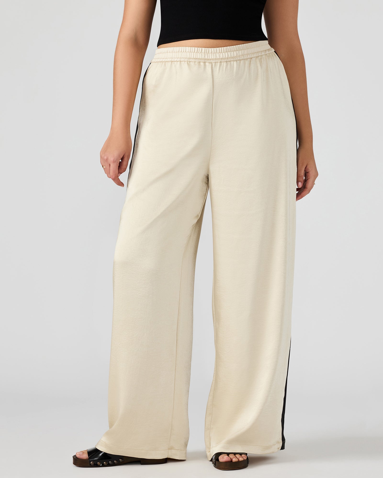 Model wearing Moxie womens pants in a casual outdoor setting.