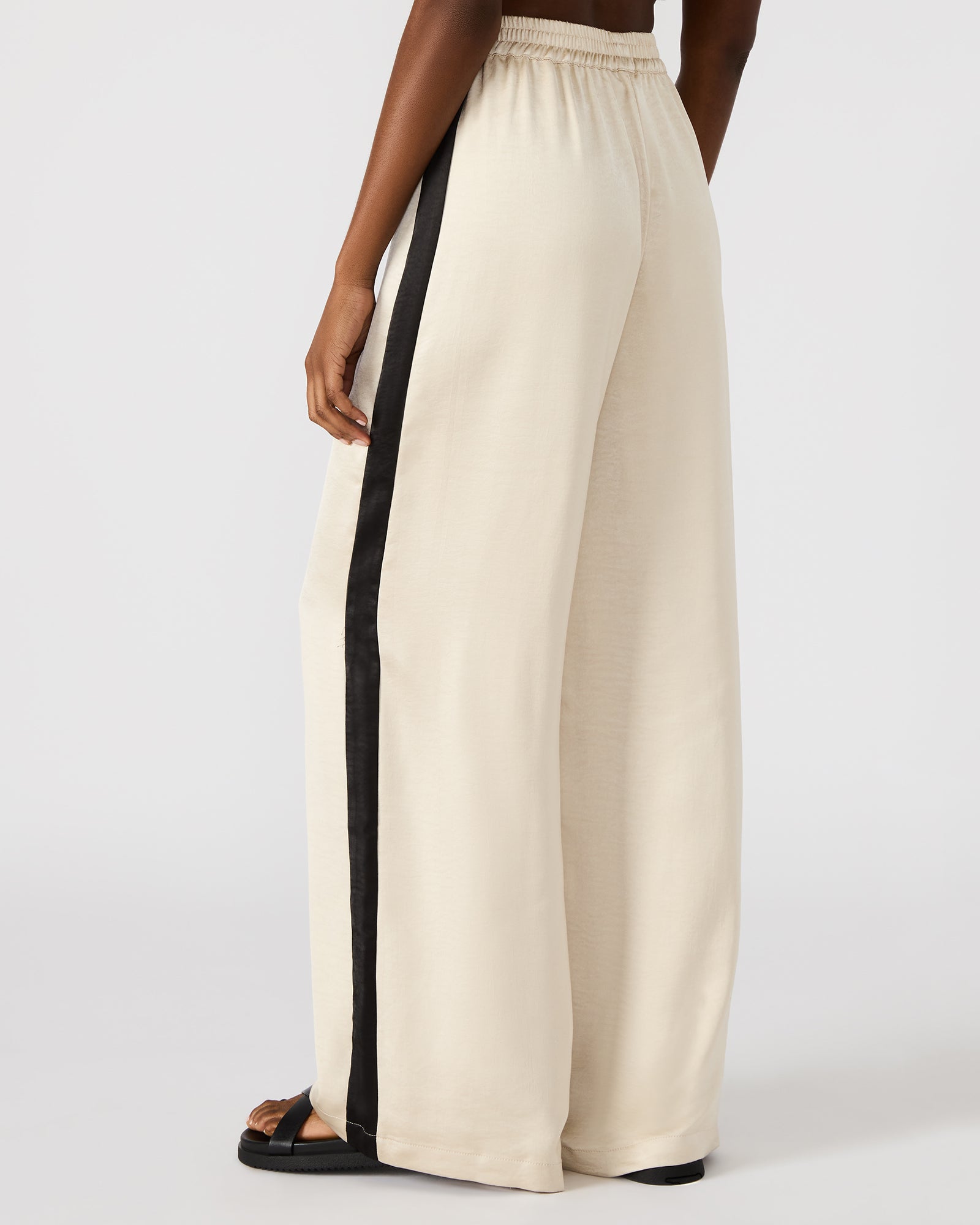 Model wearing Moxie womens pants in a casual outdoor setting.