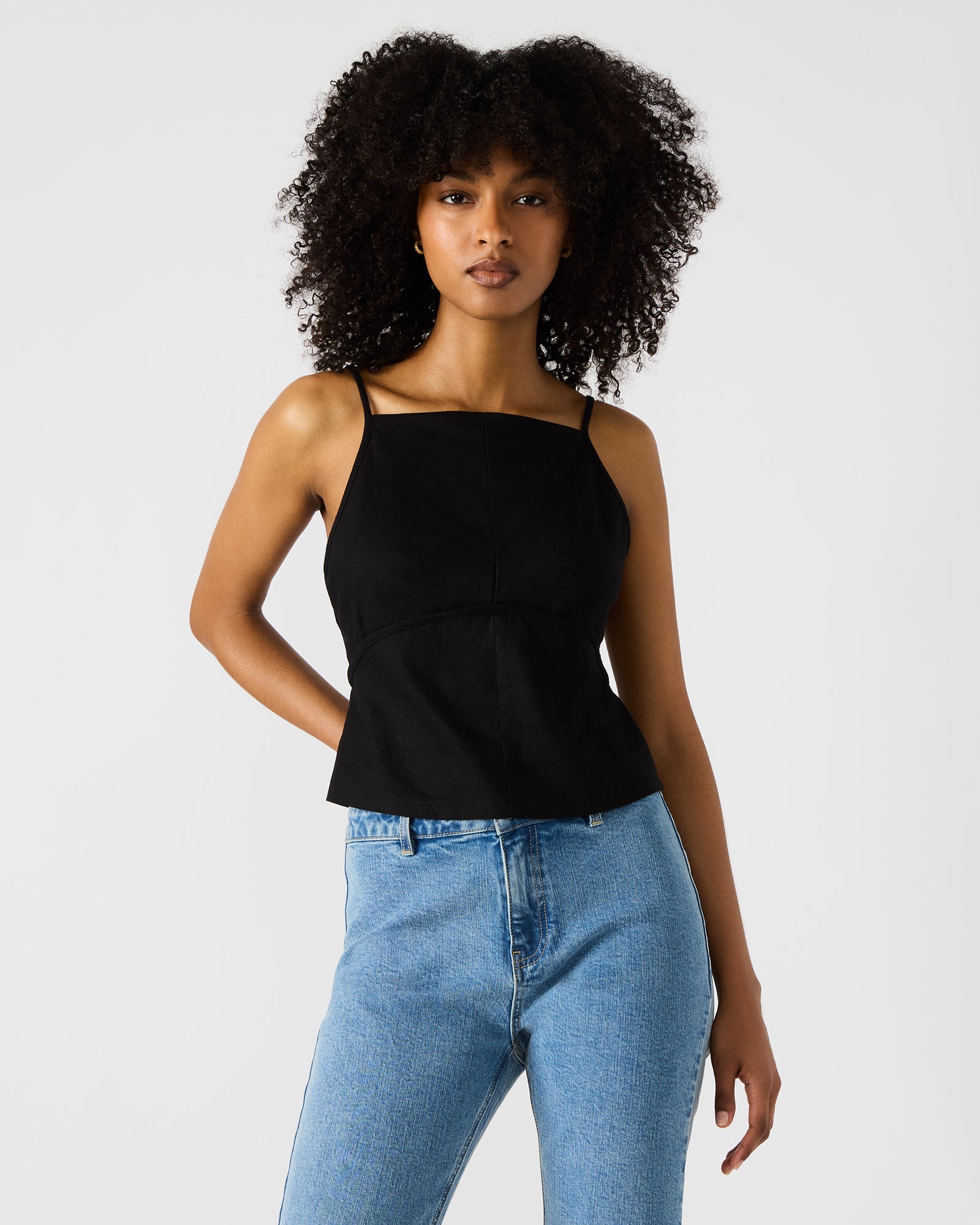 Close-up of the Tiegan black top’s square neckline and strap details