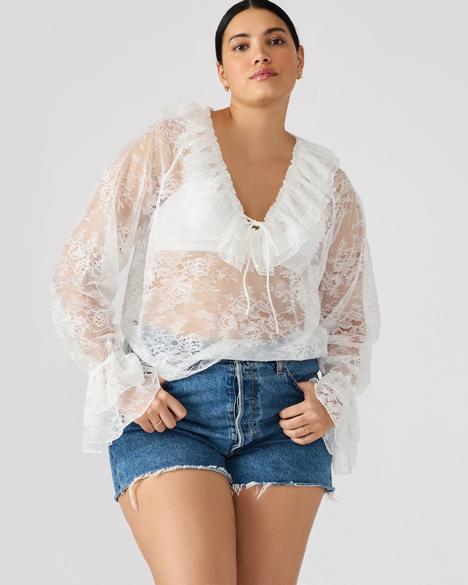 Model wearing the Hampton lace blouse with long sleeves and intricate lace details