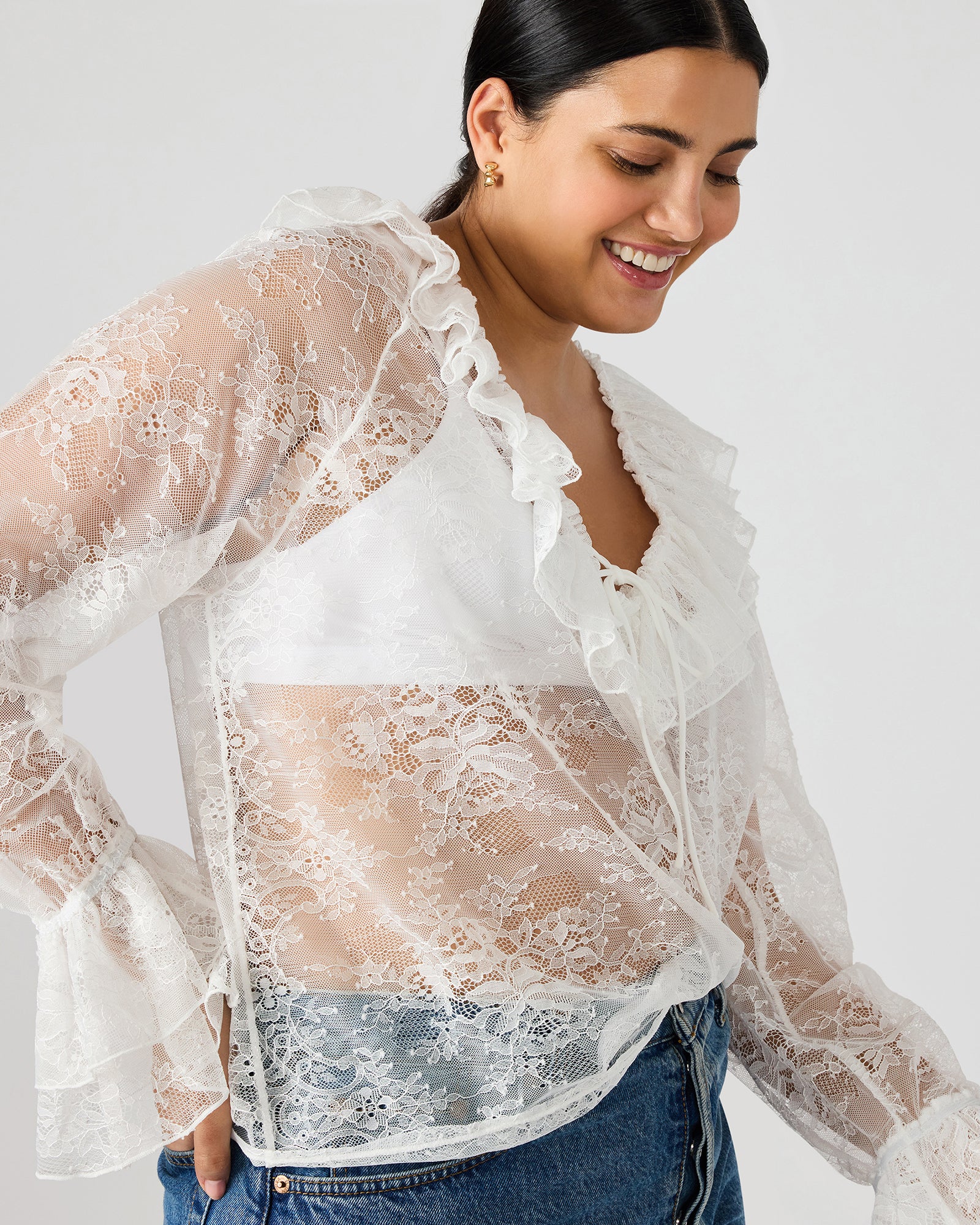 Model wearing the Hampton lace blouse with long sleeves and intricate lace details