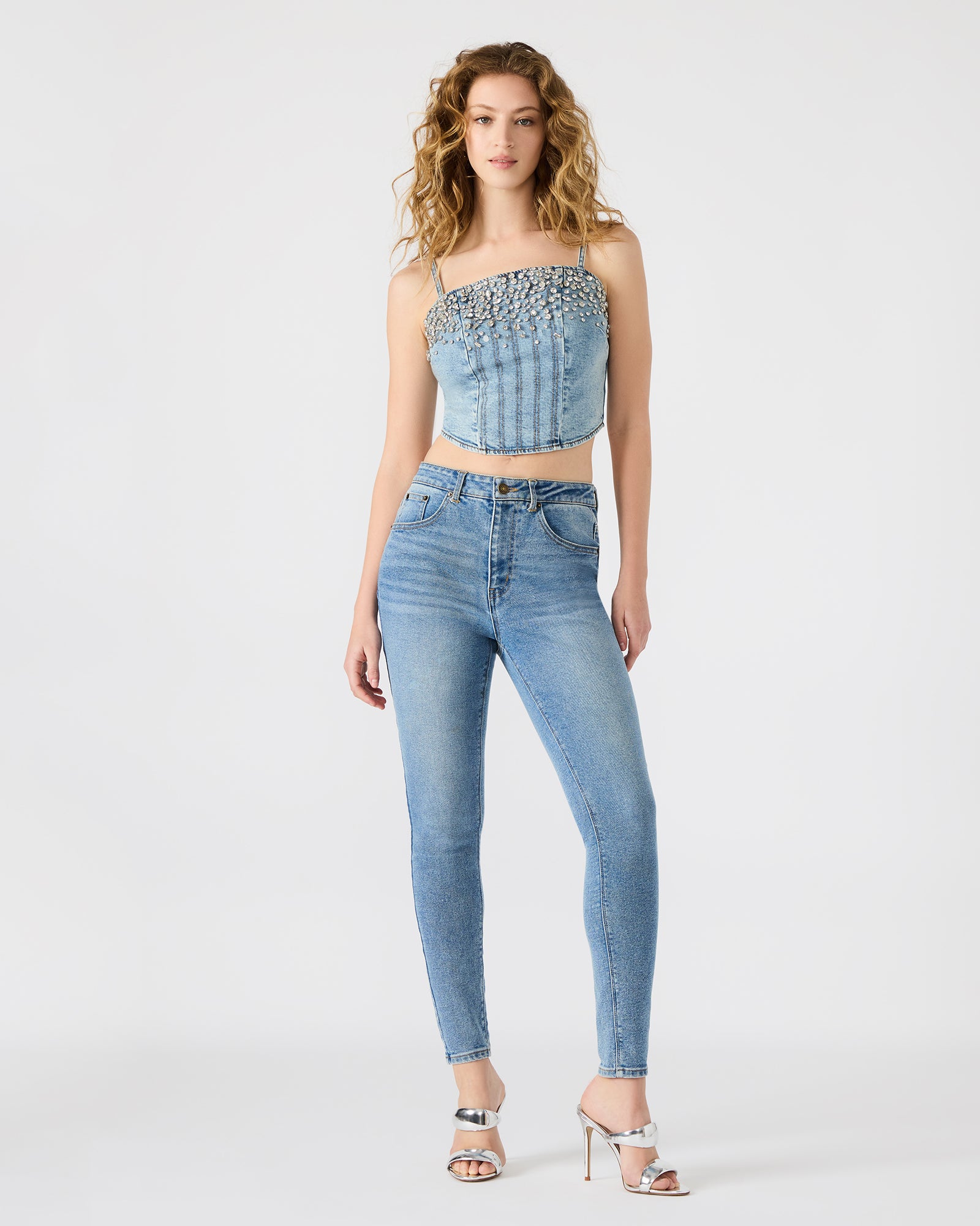 Styled crop top paired with fashion-forward accessories for a trendy look.