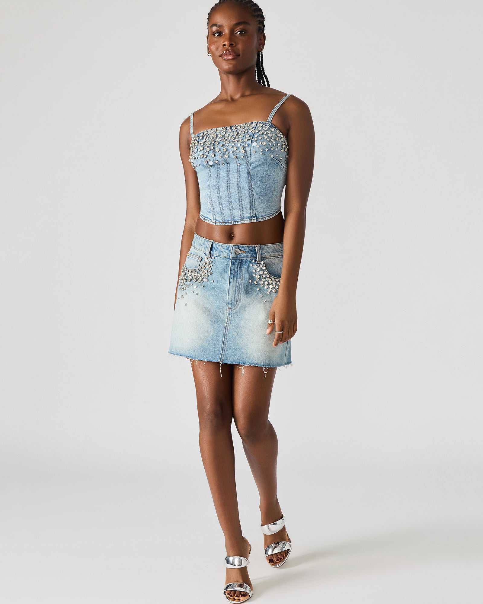 Front view of the embellished denim crop top showcasing the corset design.