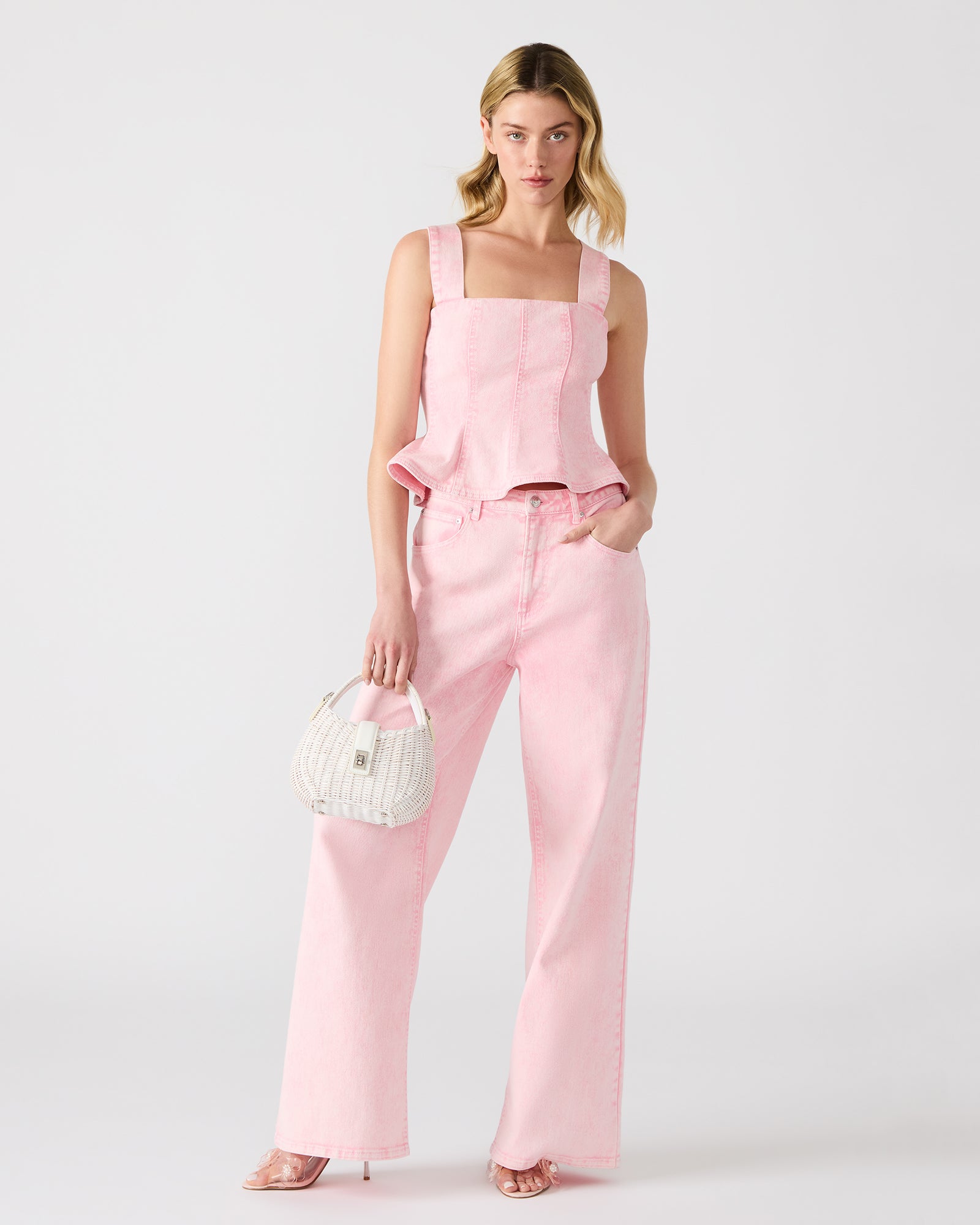 Model wearing Penelopi pink denim corset top with summer accessories