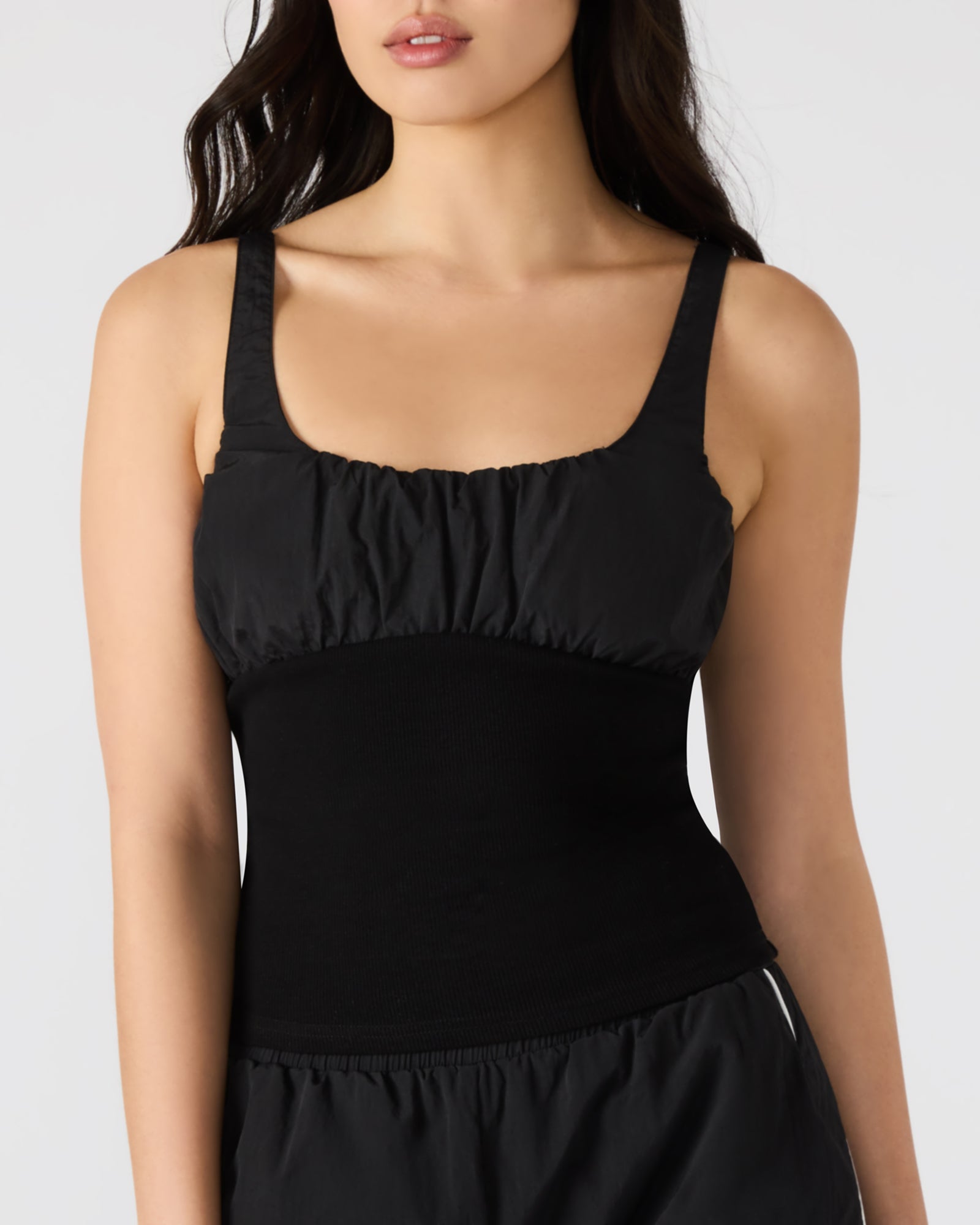Women’s tank top paired with denim shorts for a casual look