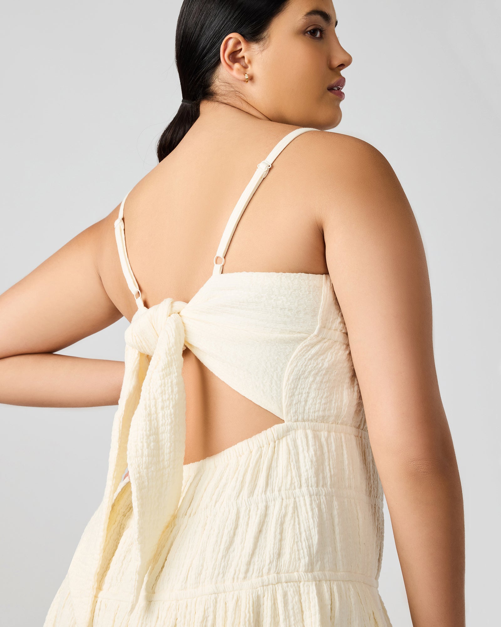 Back angle showing bow tie detail on flowy cotton dress