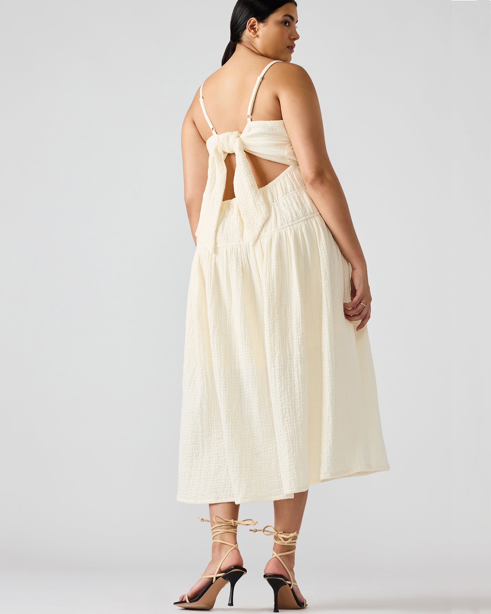 Front view of white maxi dress on model outdoors near Lake Michigan