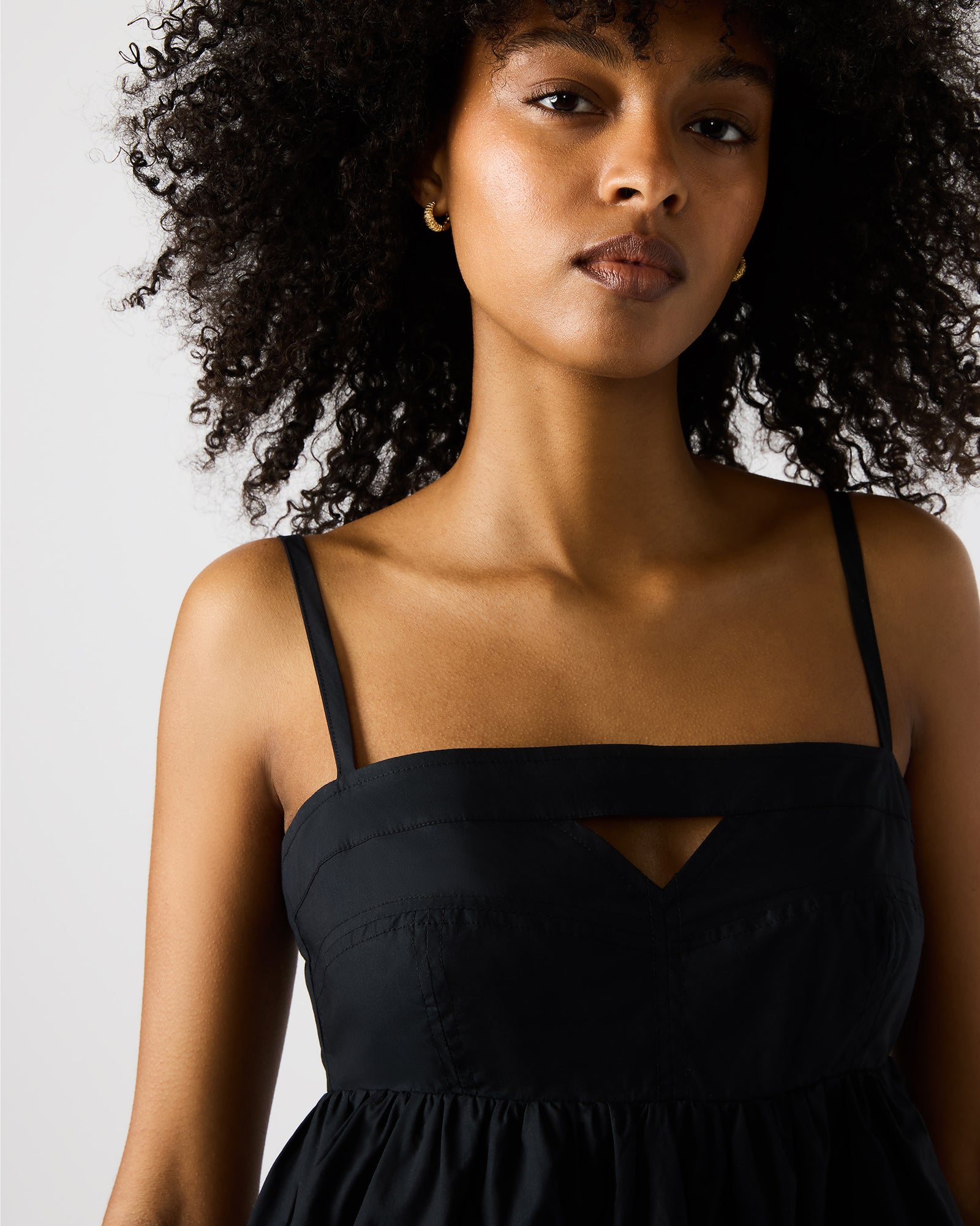 Back view of the cutout dress highlighting cotton texture and fit