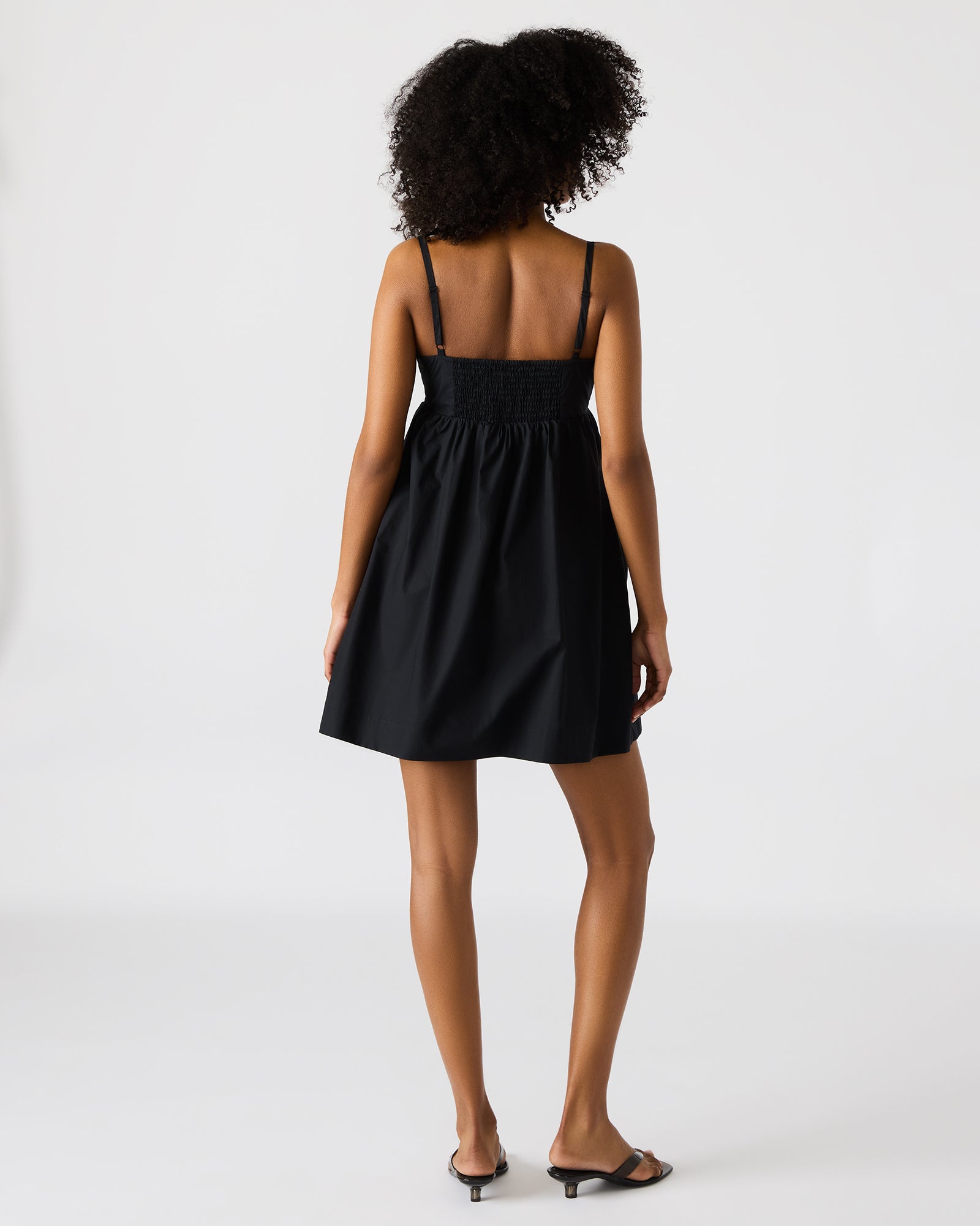 Back view of the cutout dress highlighting cotton texture and fit