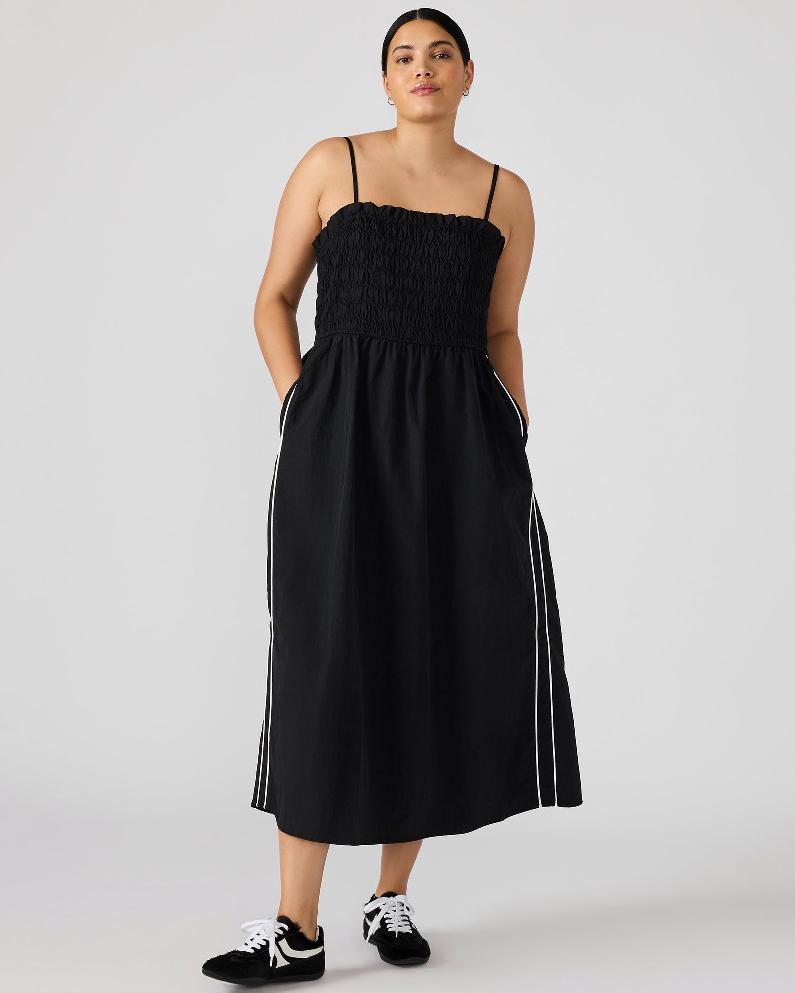 Front view of the black and white striped maxi dress showcasing the smocked top.