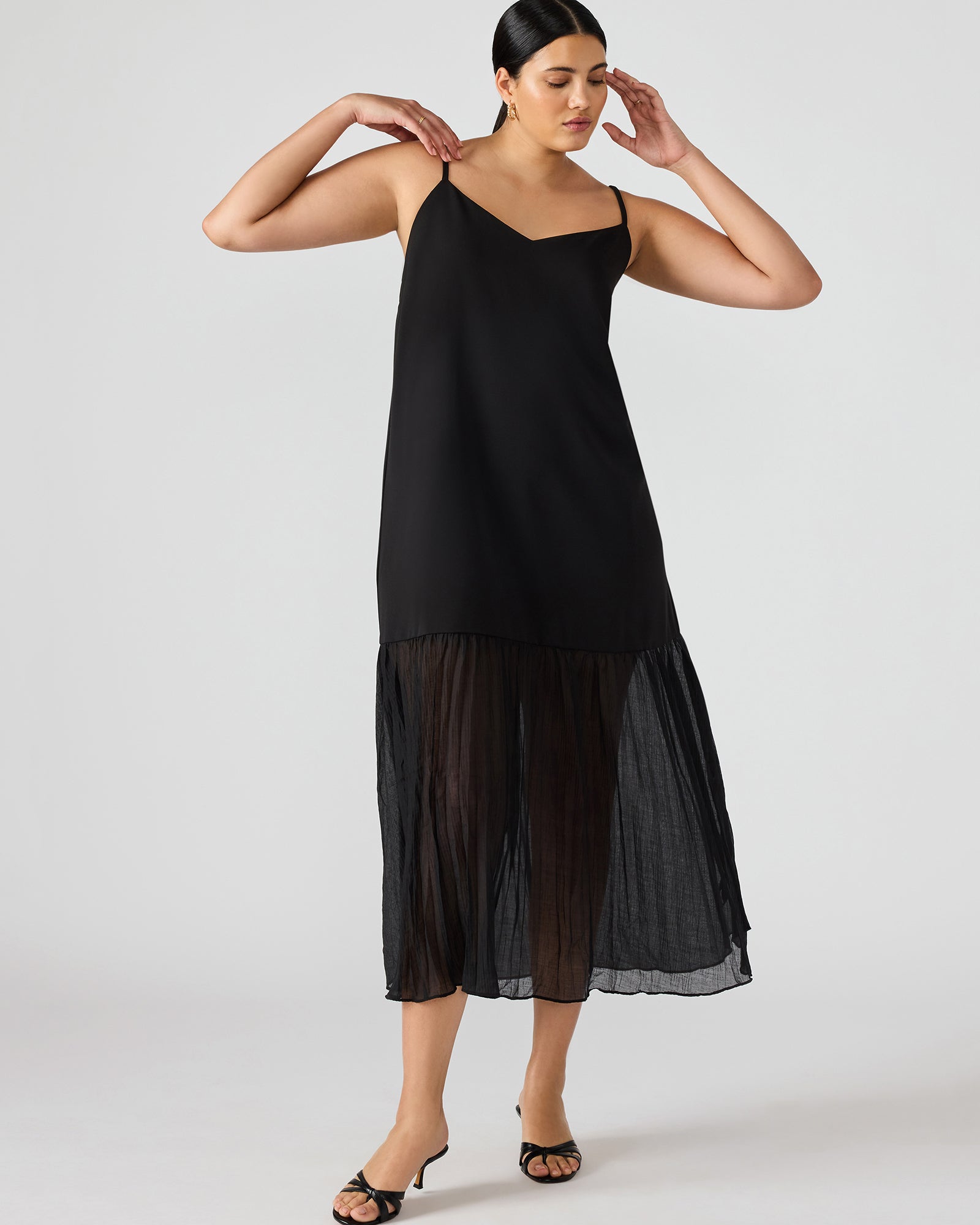 Model wearing the black lace maxi dress at a summer event.