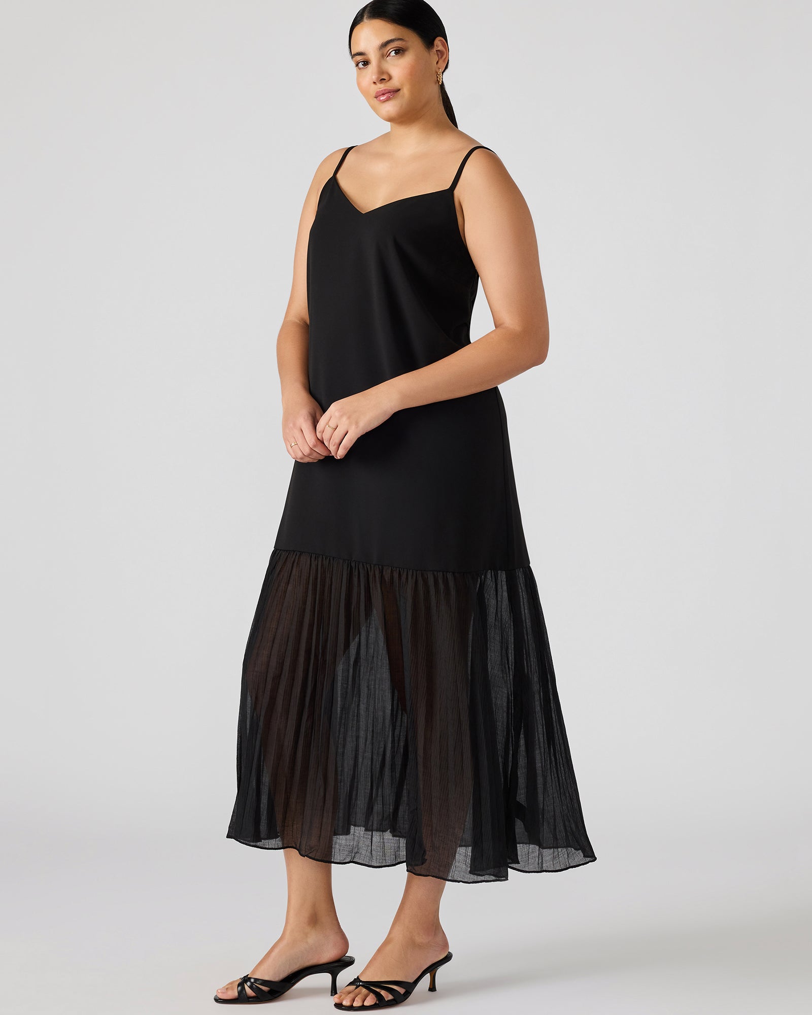 Side view showcasing the flowy skirt of the black lace maxi dress.