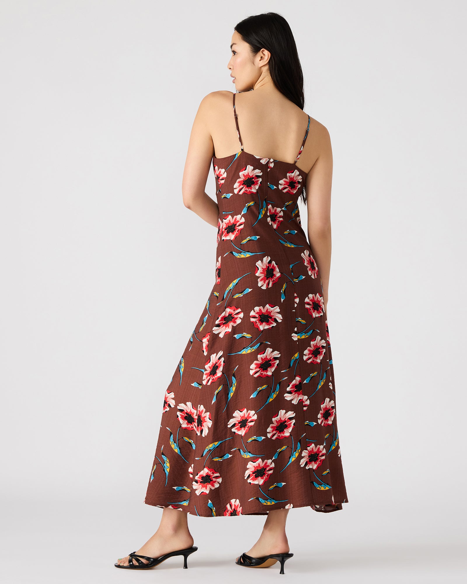 Close-up of the chocolate brown maxi dress showcasing floral details and beaded straps.