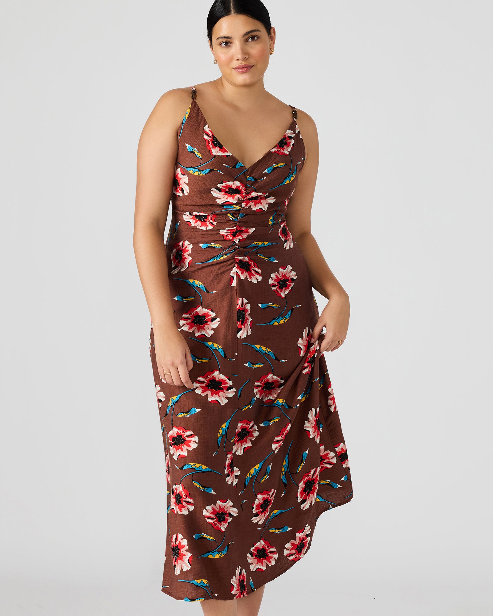 Close-up of the chocolate brown maxi dress showcasing floral details and beaded straps.