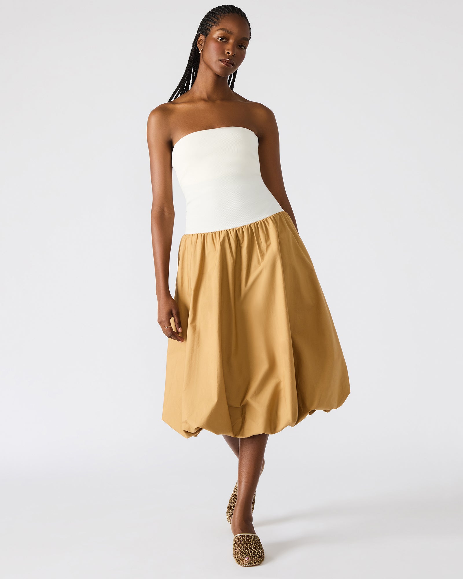 Front view of the taupe midi strapless dress on a model