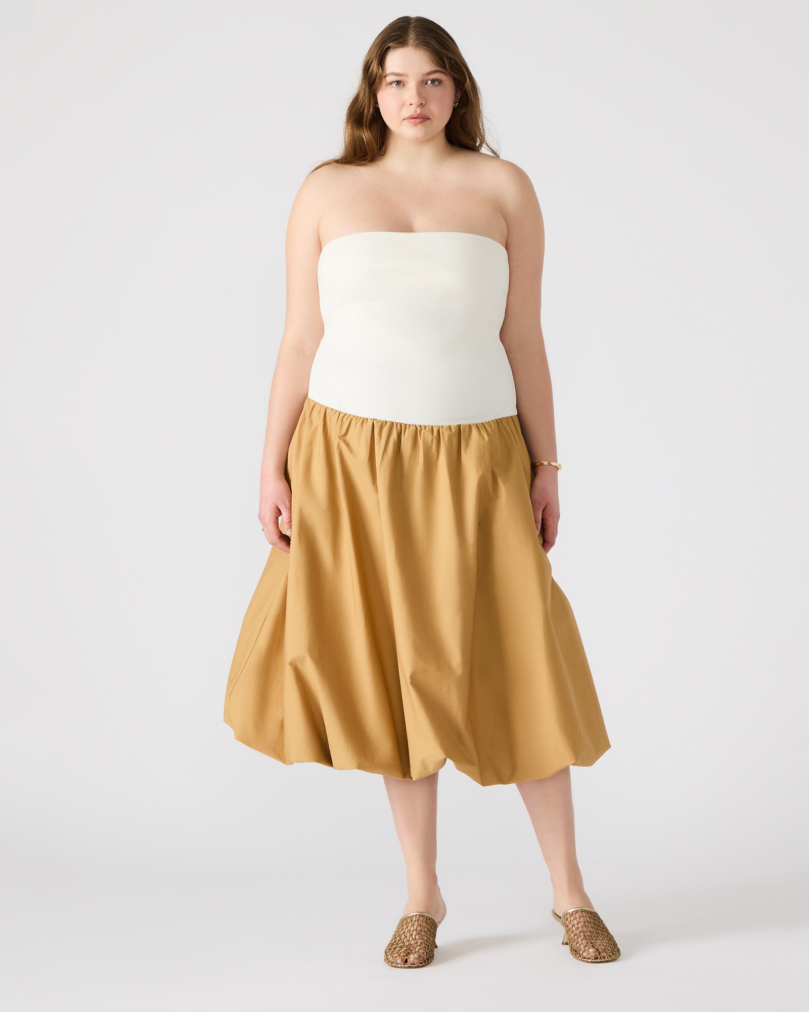 Side view of the chic strapless dress highlighting the bubble skirt