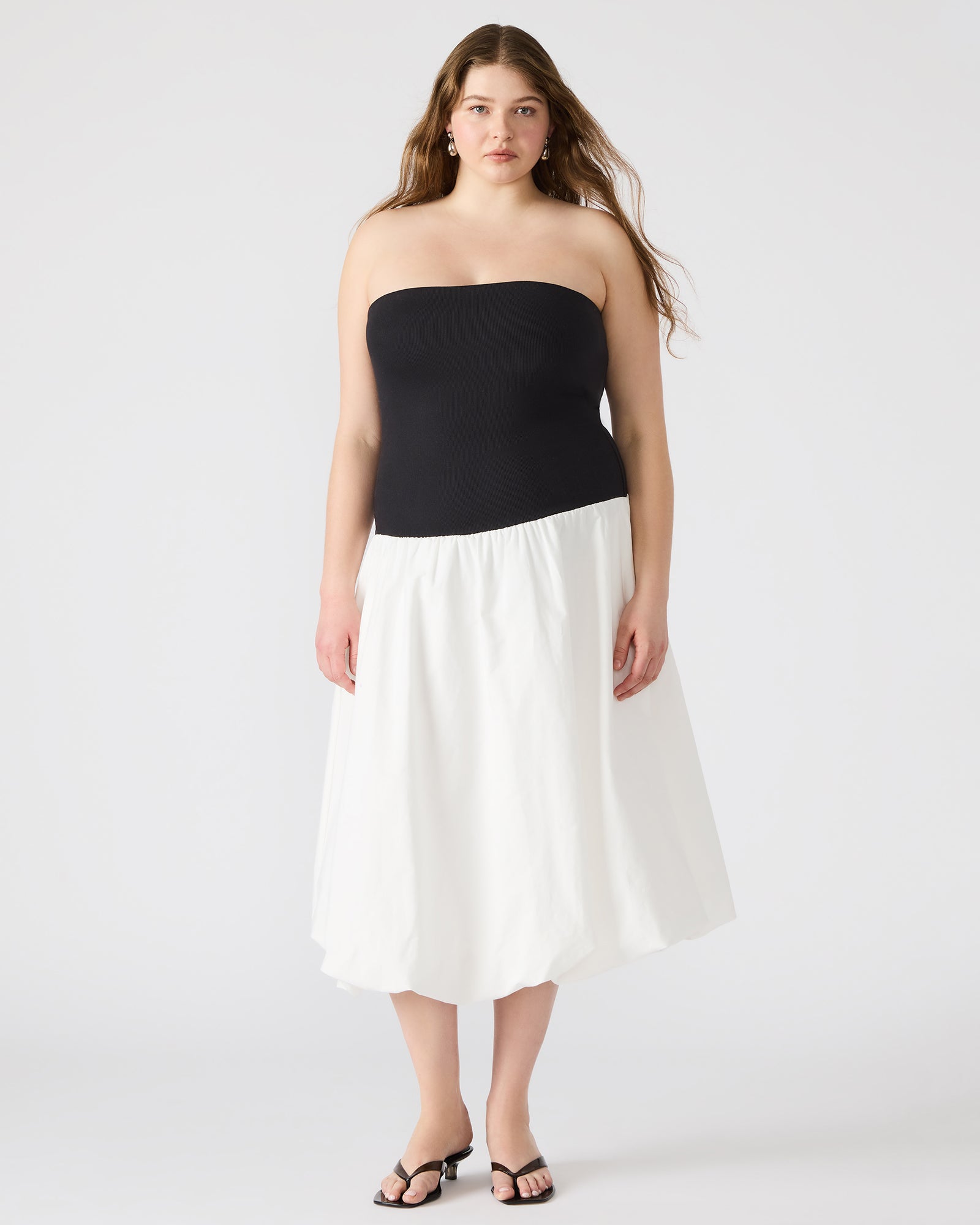 Side angle of the strapless mini dress, highlighting the cotton fabric