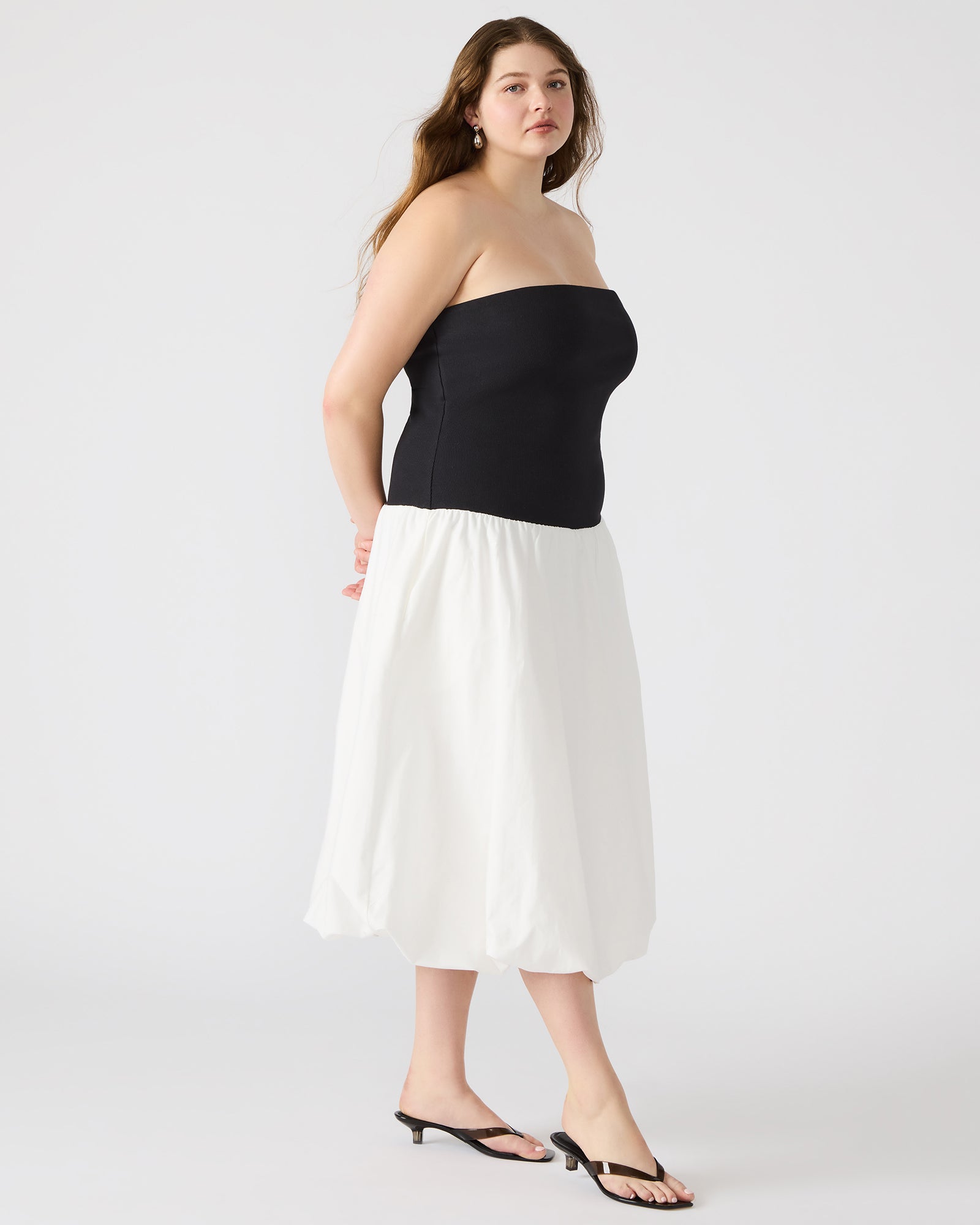 Side angle of the strapless mini dress, highlighting the cotton fabric