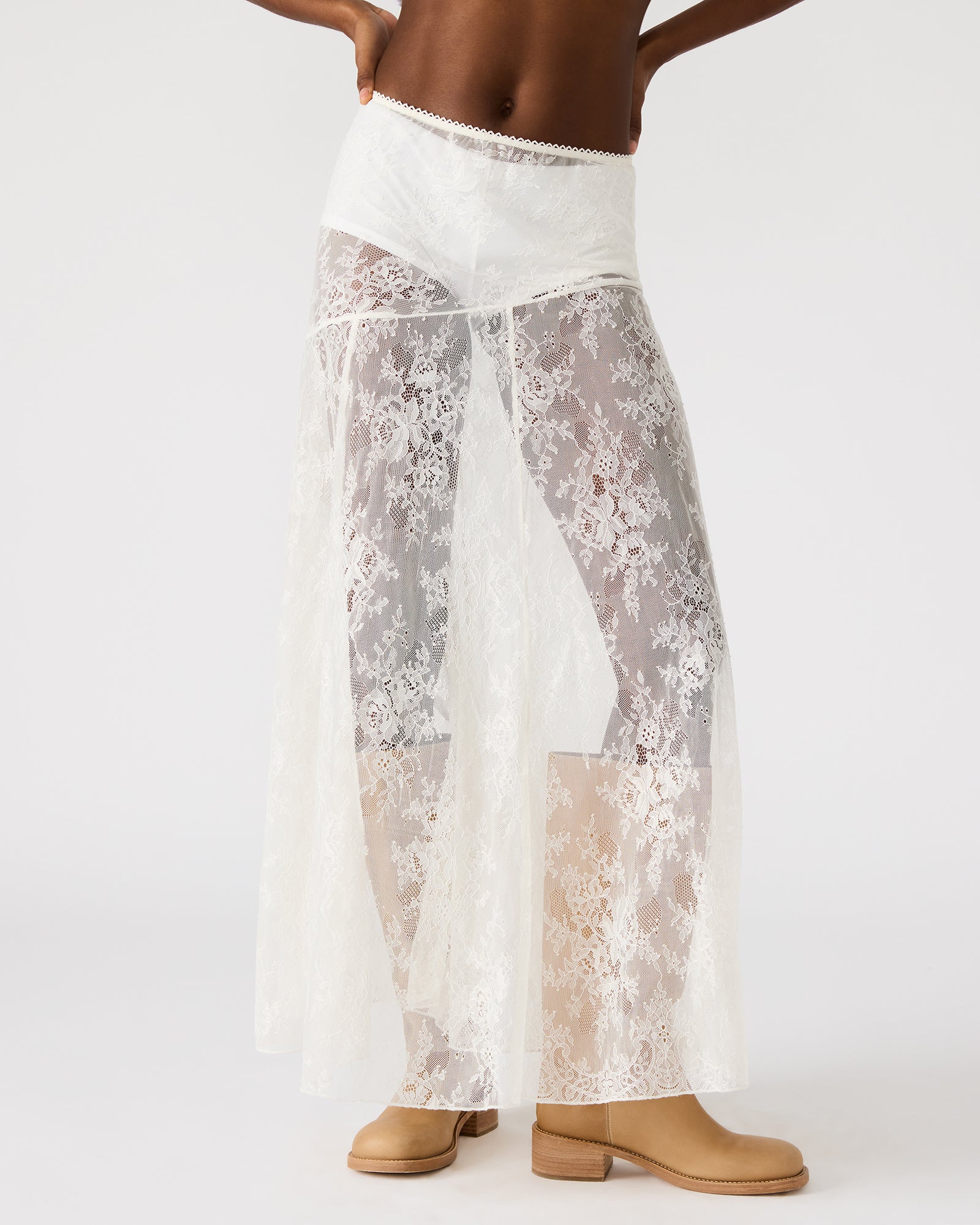 Side view of the flowy white lace skirt, highlighting its sheer mesh design.