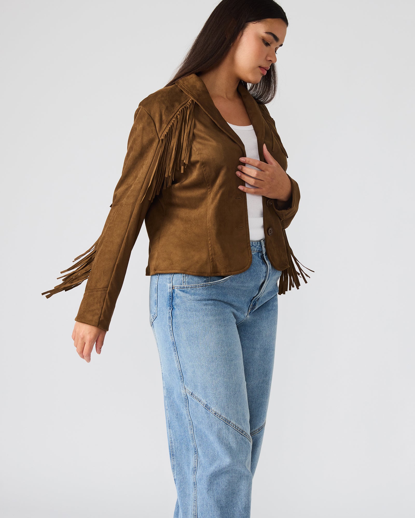 Side angle of suede bomber jacket styled over denim in fall setting