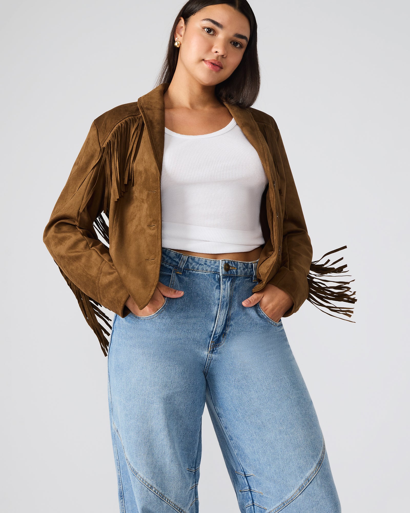 Model wearing a chestnut fringe jacket with western-inspired detailing, shot outdoors
