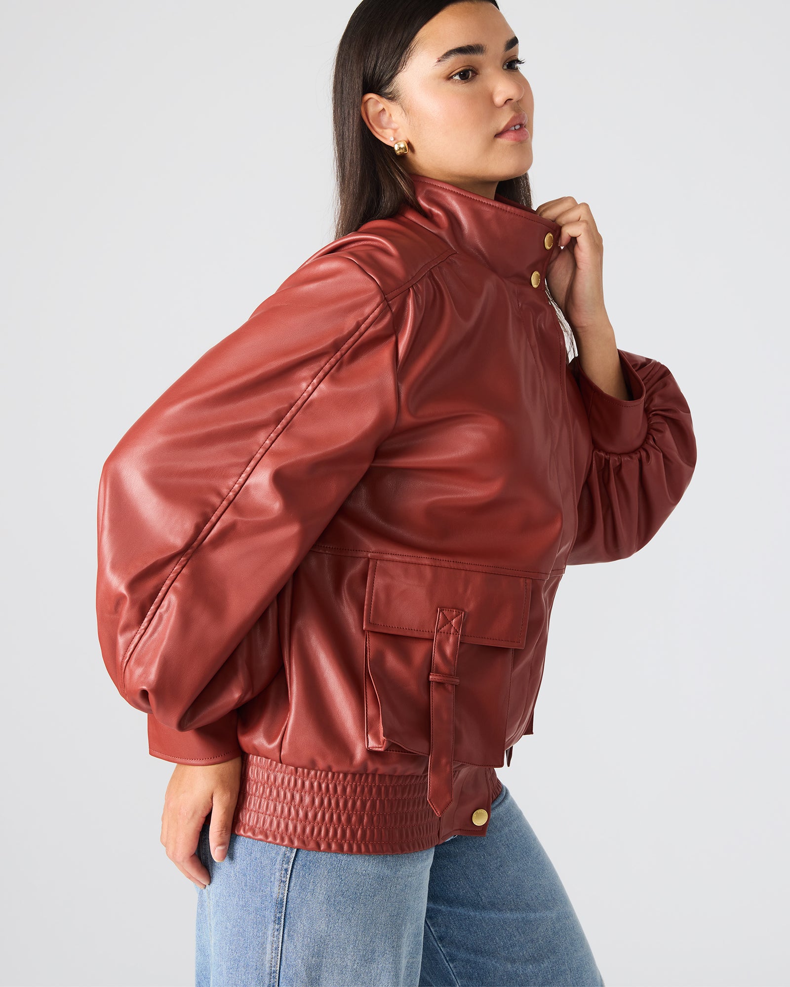Close-up of the button-up closure and collar of the faux leather jacket.