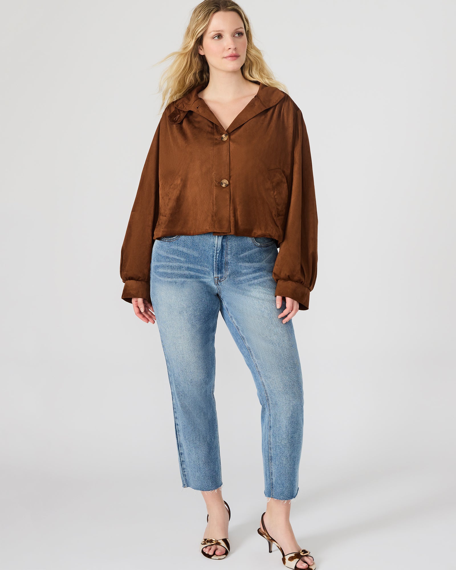 Model wearing the chicory coffee ladies faux suede jacket in an outdoor setting, highlighting its versatility.