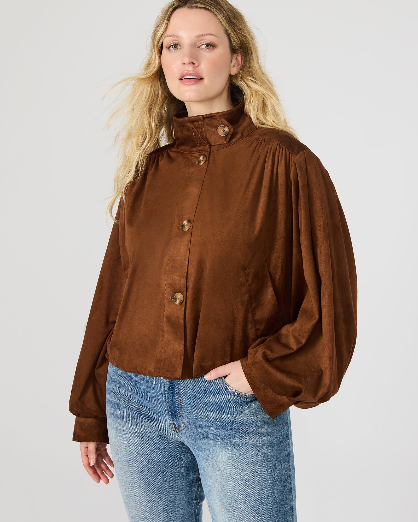 Detailed close-up of the button-up closure and collar of the faux suede jacket womens.
