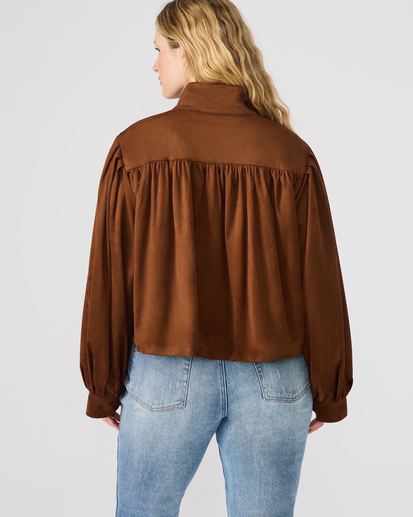 Front view of the chicory coffee faux suede bomber jacket on a model, showcasing its stylish design.