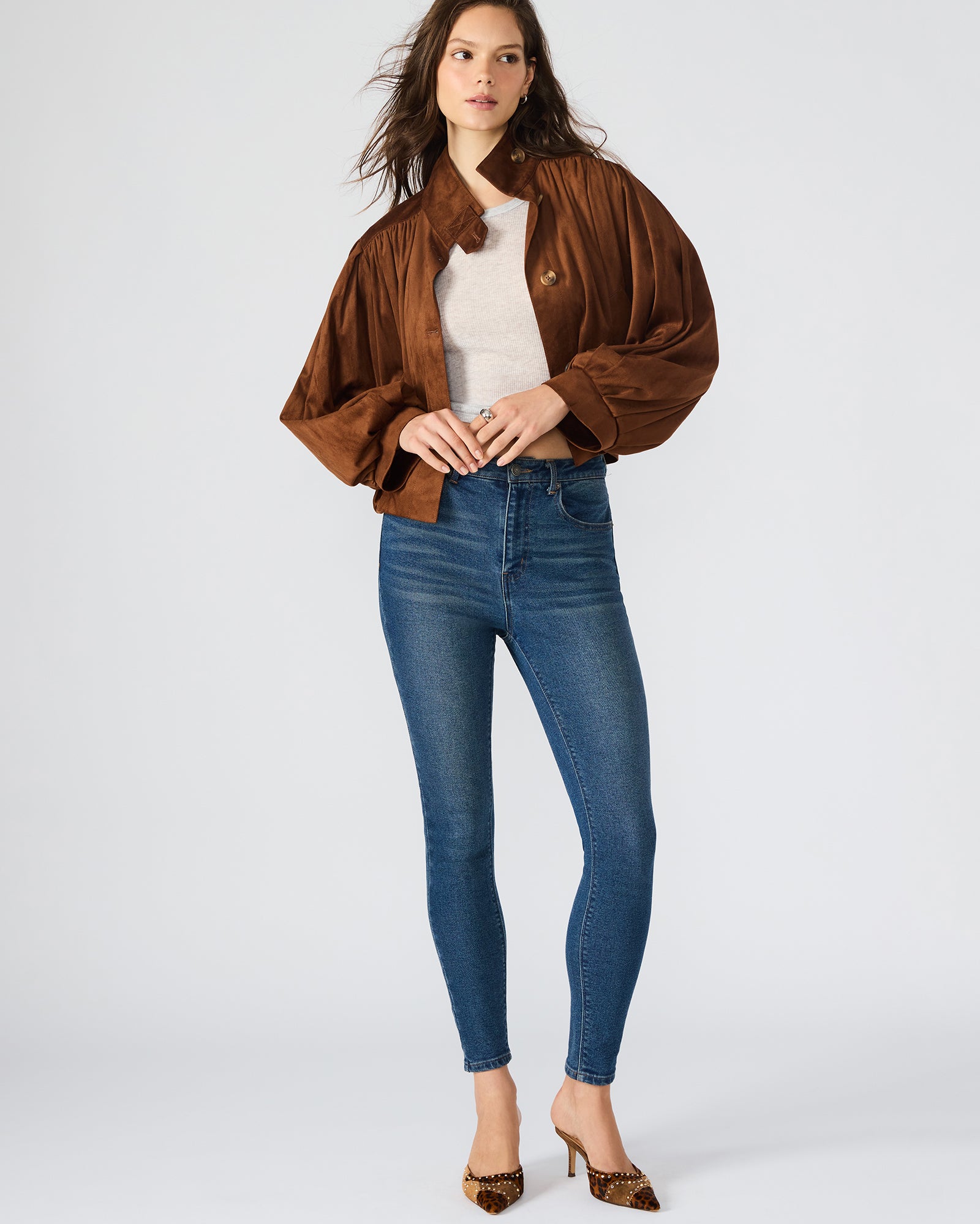Detailed close-up of the button-up closure and collar of the faux suede jacket womens.