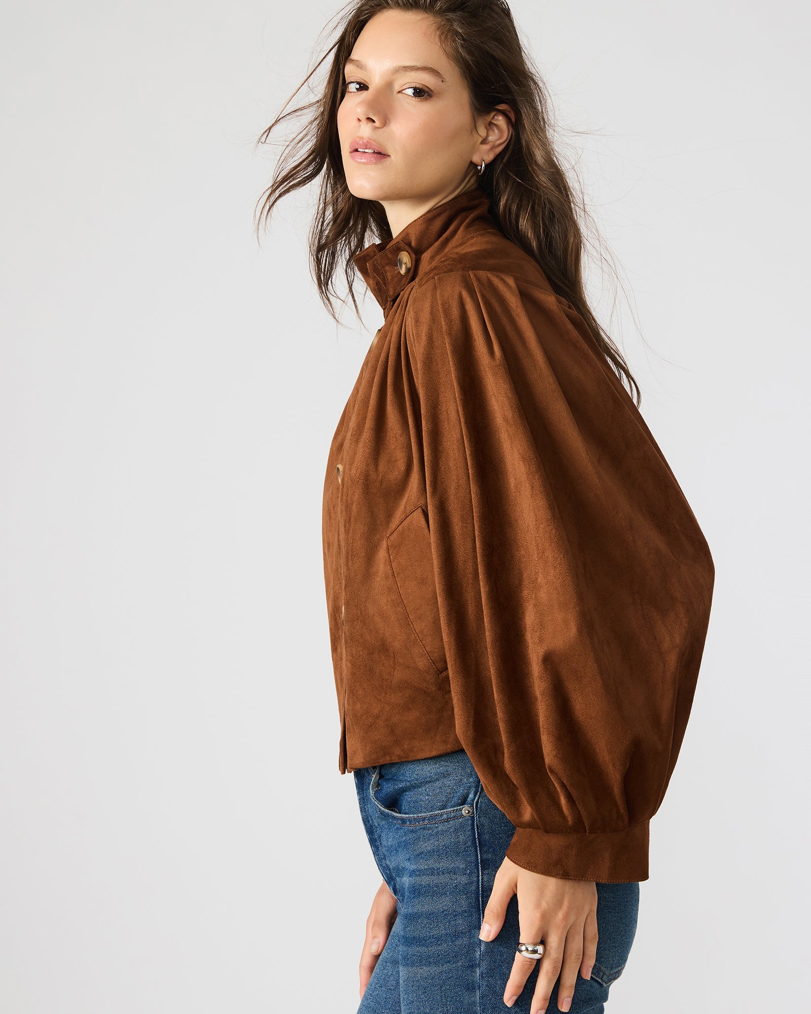 Model wearing the chicory coffee ladies faux suede jacket in an outdoor setting, highlighting its versatility.