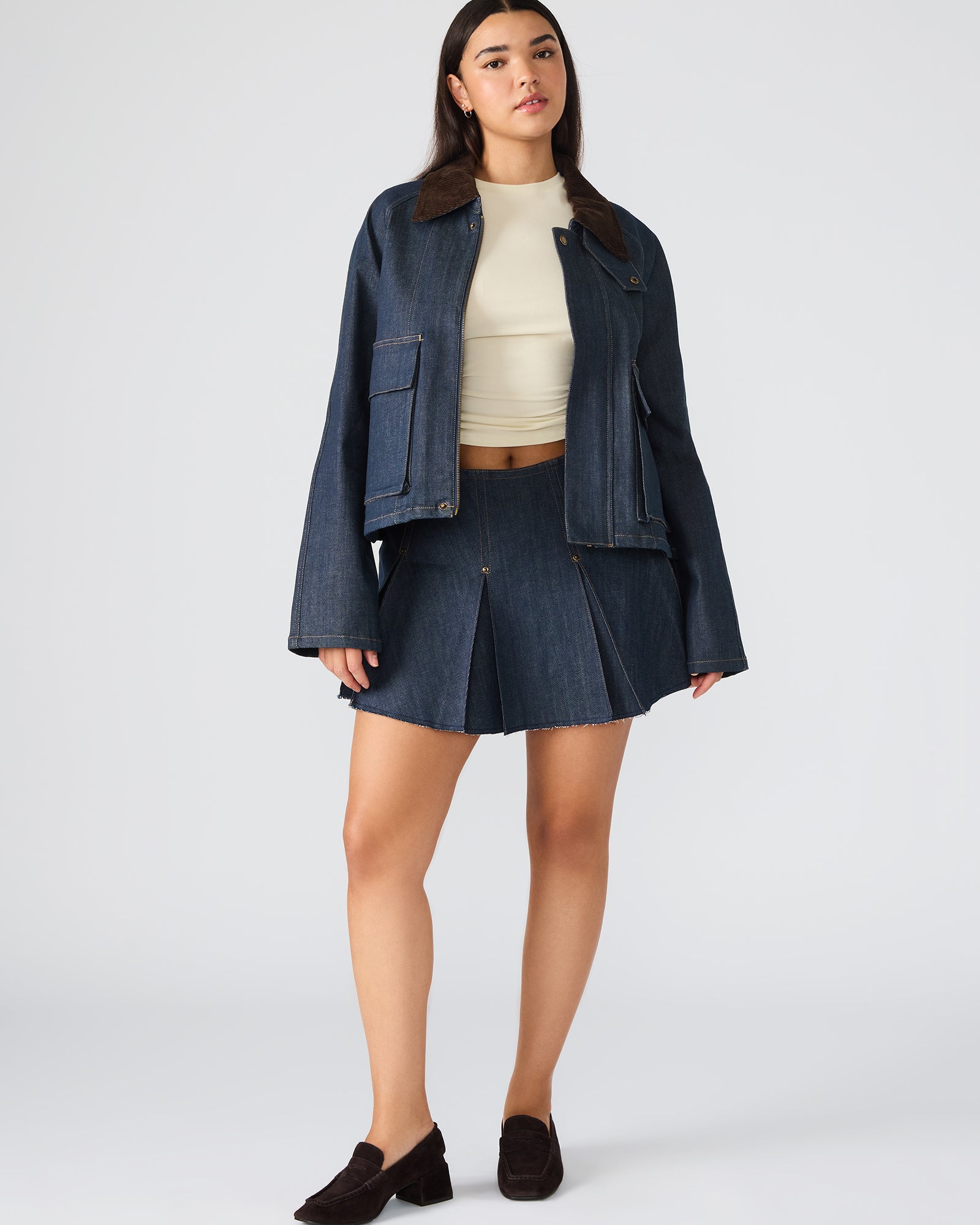 Side view of the oversized denim jacket highlighting its functional pockets and relaxed fit.