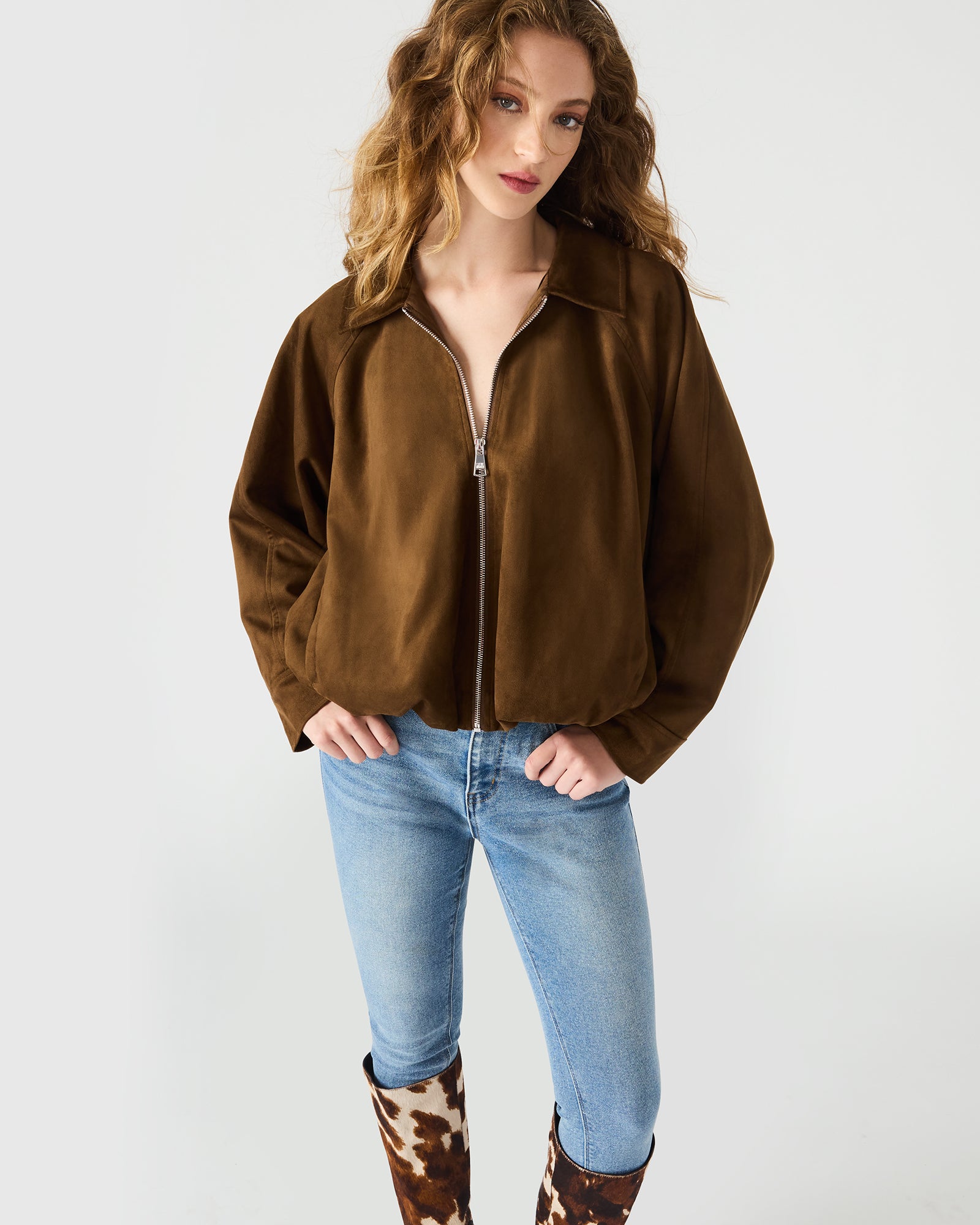 Front view of chestnut zip-up jacket styled with fall accessories