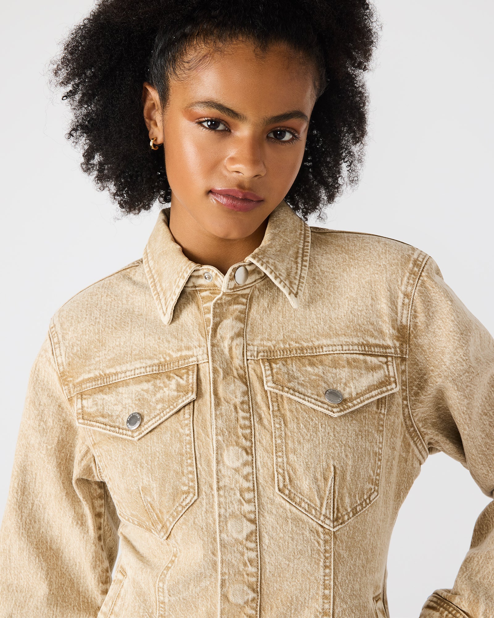 Close-up of the Parc jacket’s button-up closure and textured denim fabric