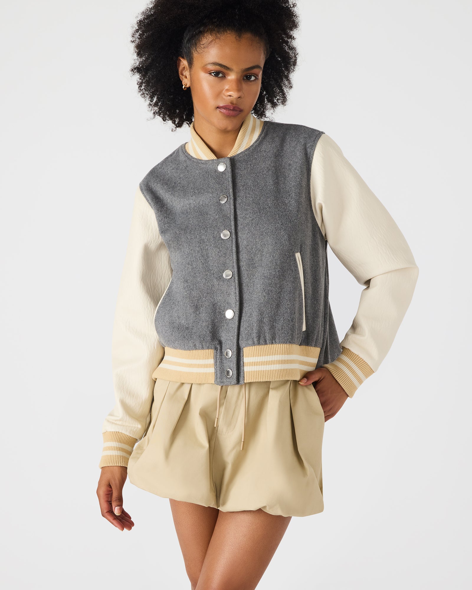 Side view of the varsity jacket mens design, featuring contrasting leather sleeves.