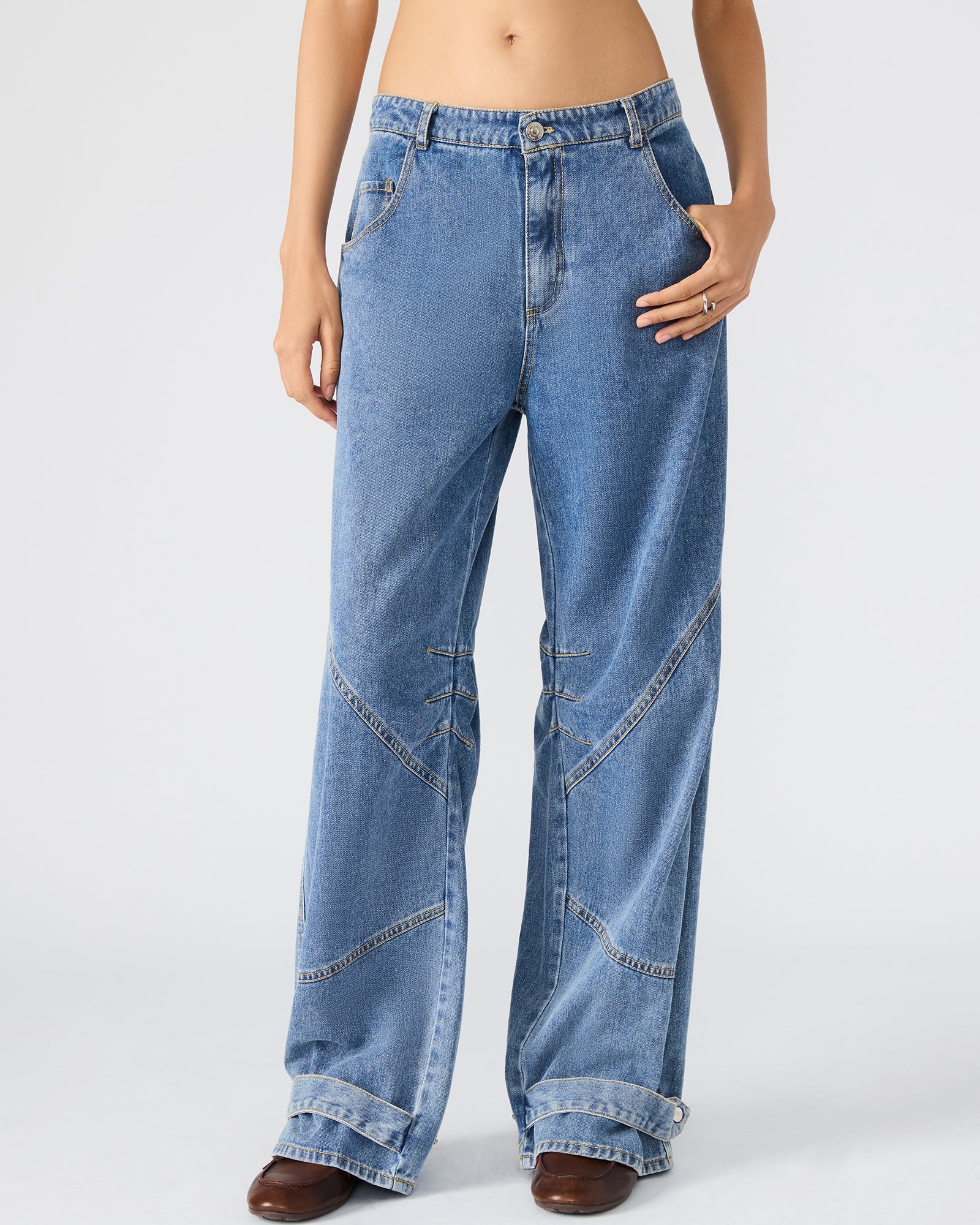 Side view of low rise bootcut jeans styled for a casual look.