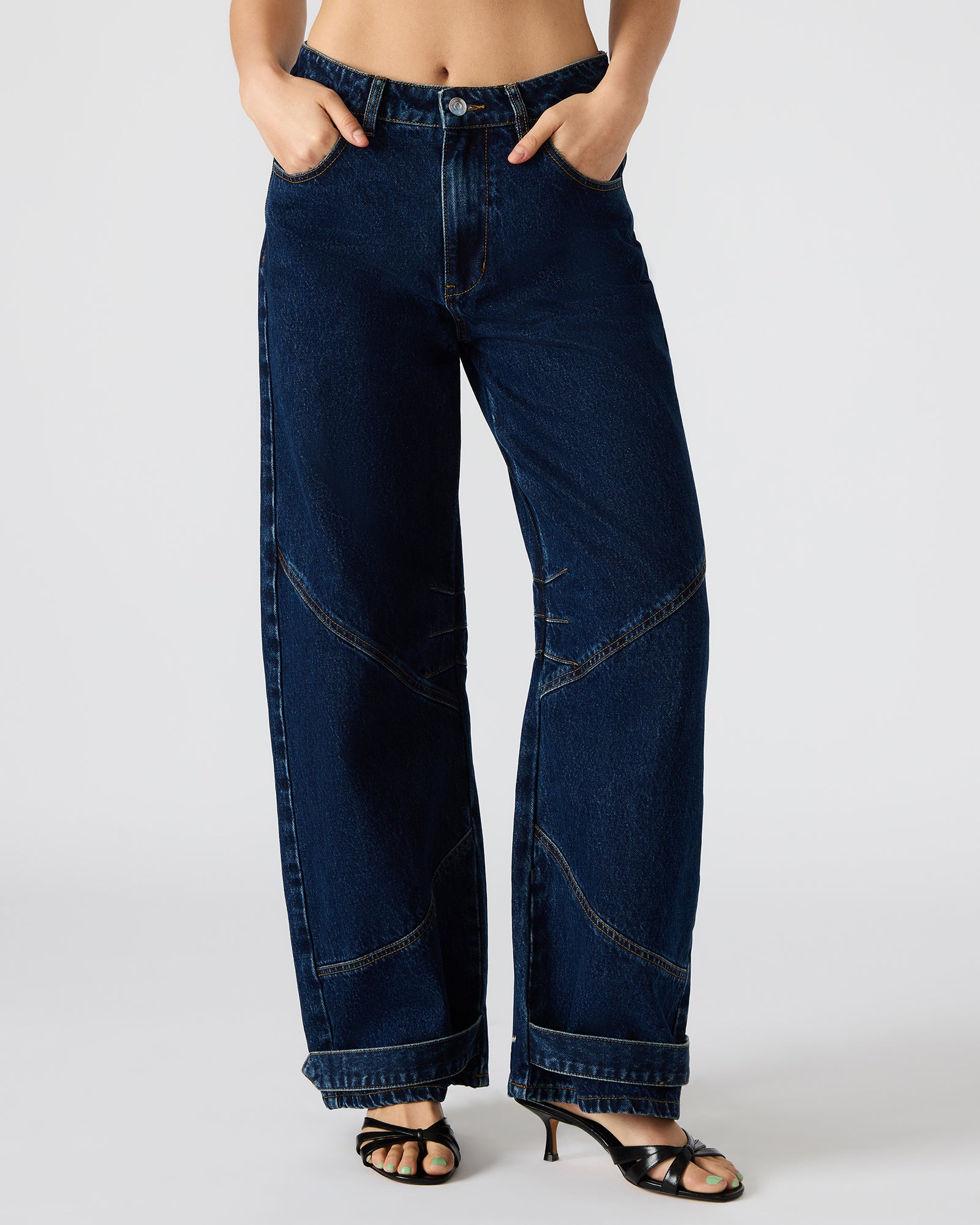 Close-up of the barrel-cut design and button closure on these mens jeans.