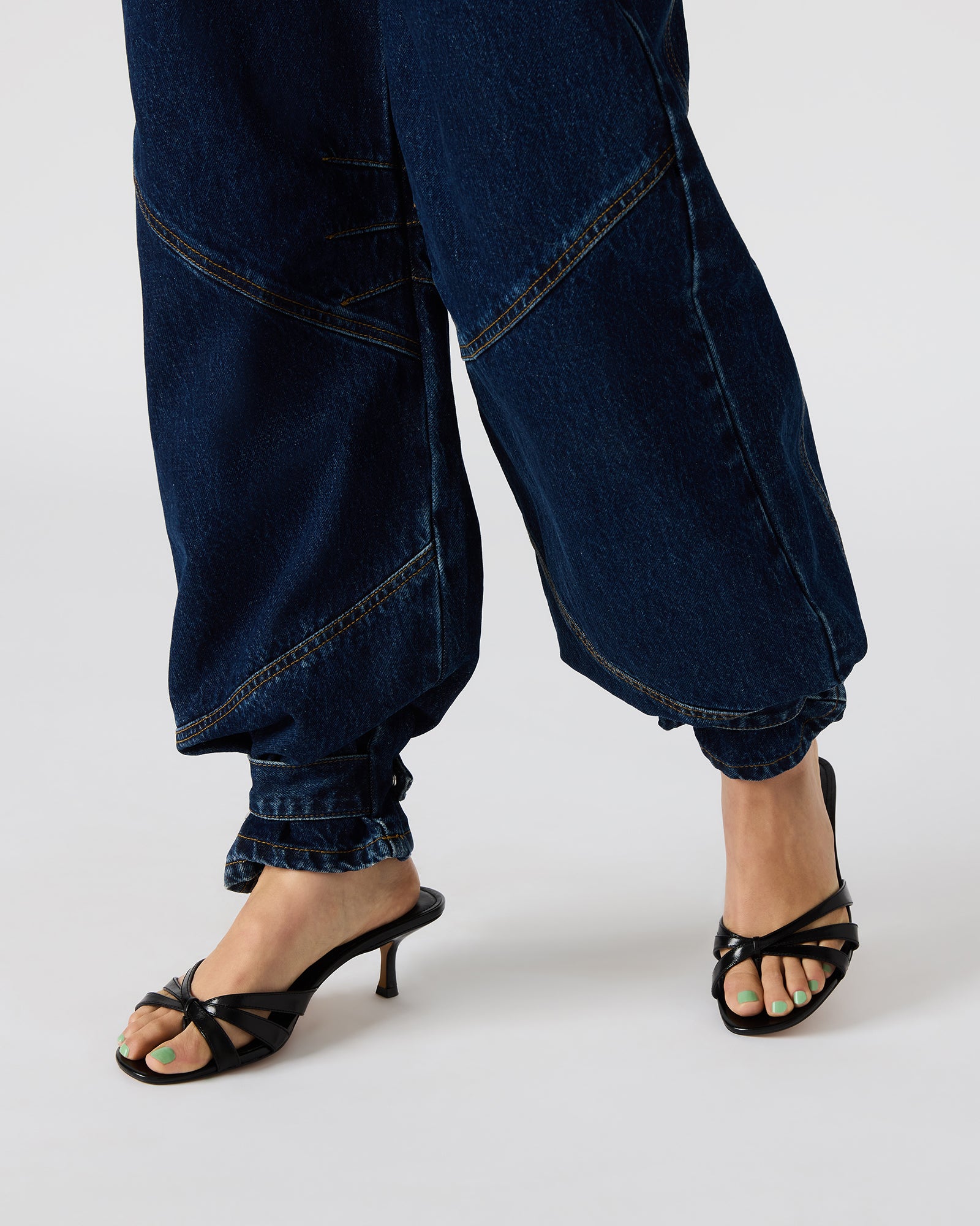 Close-up of the barrel-cut design and button closure on these mens jeans.