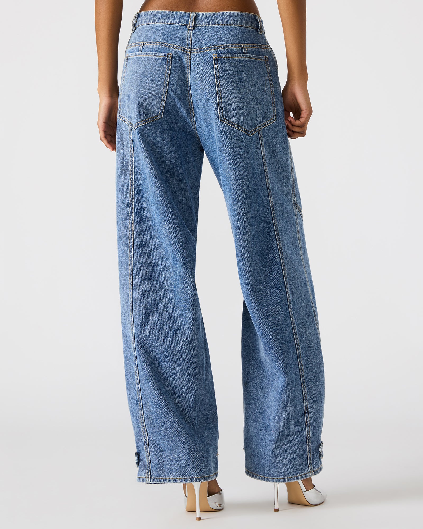Front view of women’s barrel jeans styled with a tucked-in blouse, showcasing the relaxed fit.