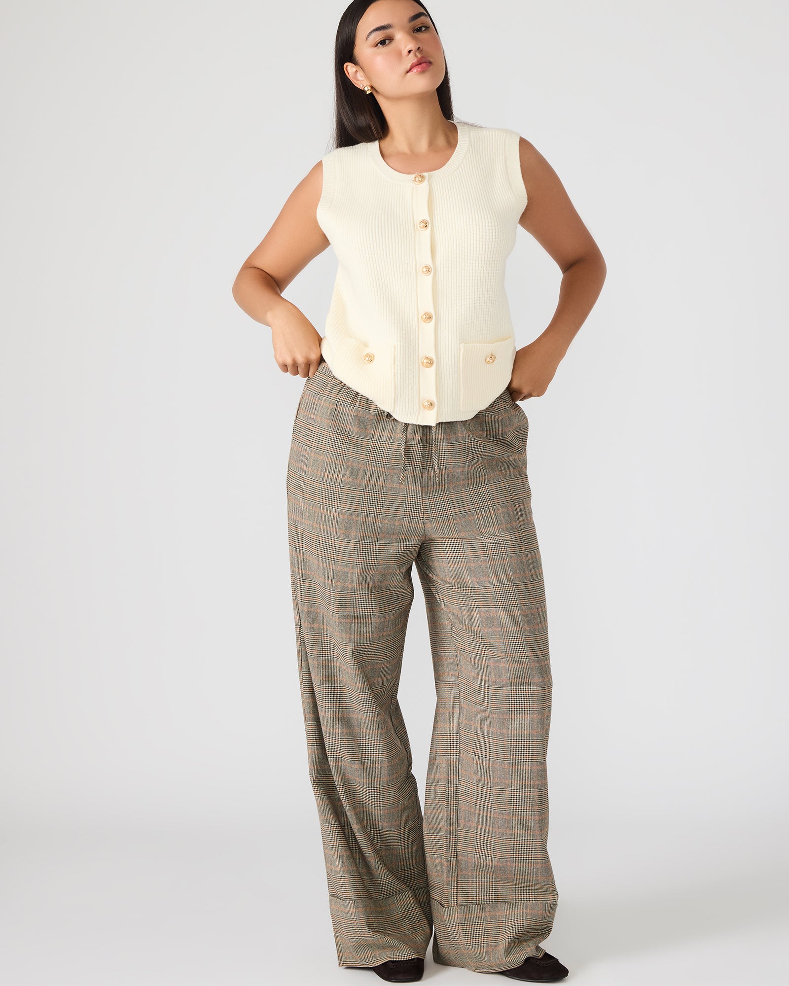 Women’s plaid pull-on pants with tie-front sitting stylishly on a chair