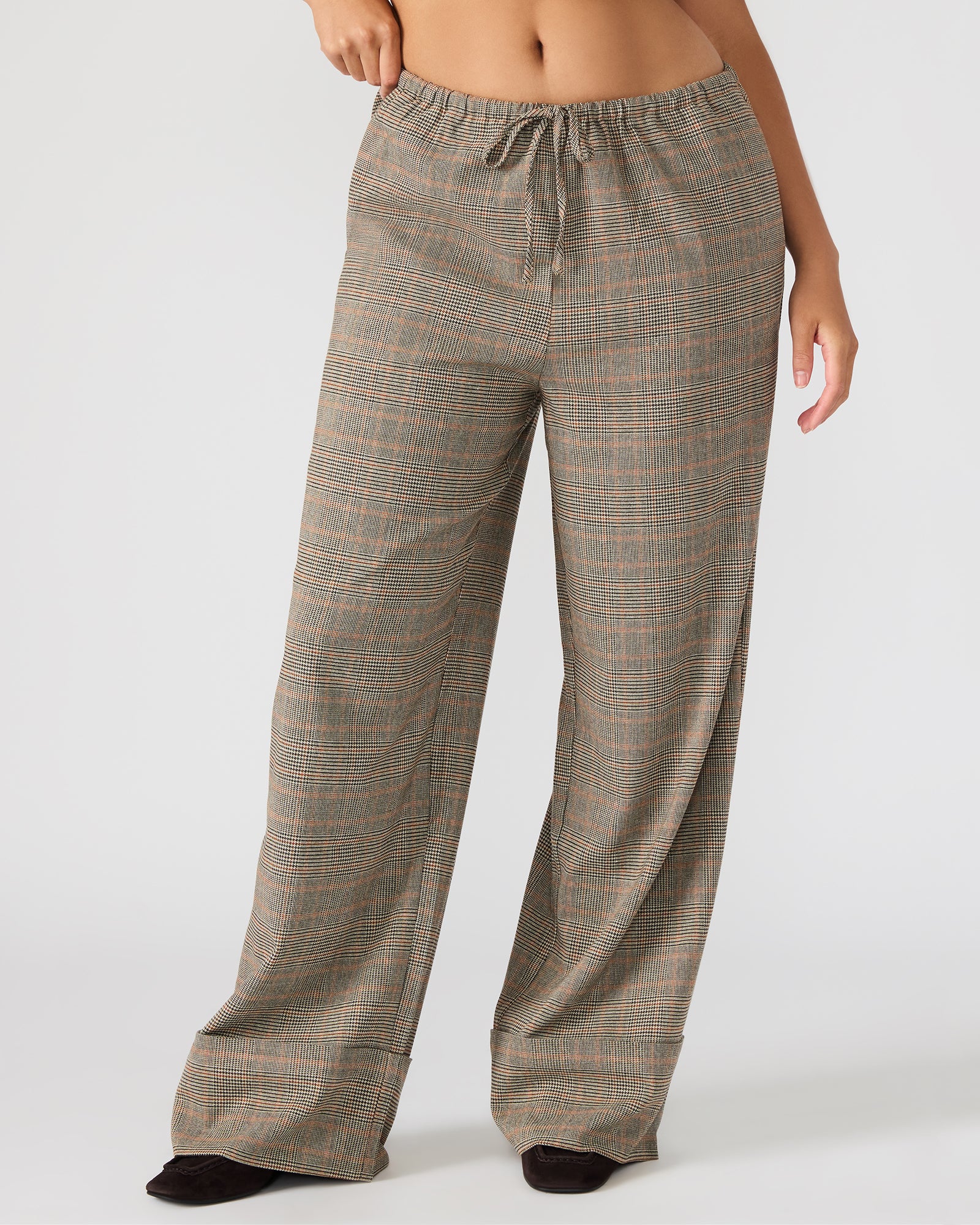 Side view of women’s plaid pants with cuffed hem and functional pockets