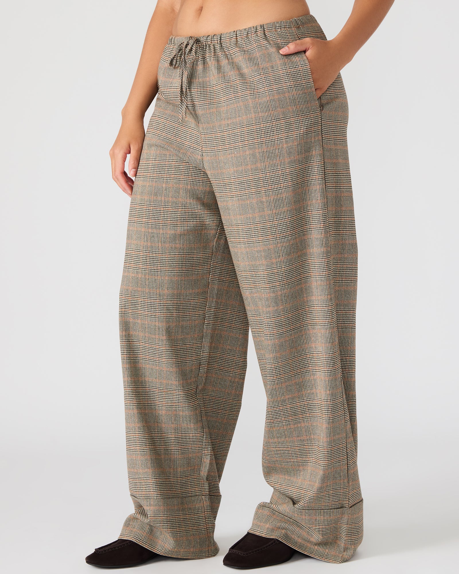Model wearing plaid pants with a casual top, showcasing comfortable fit