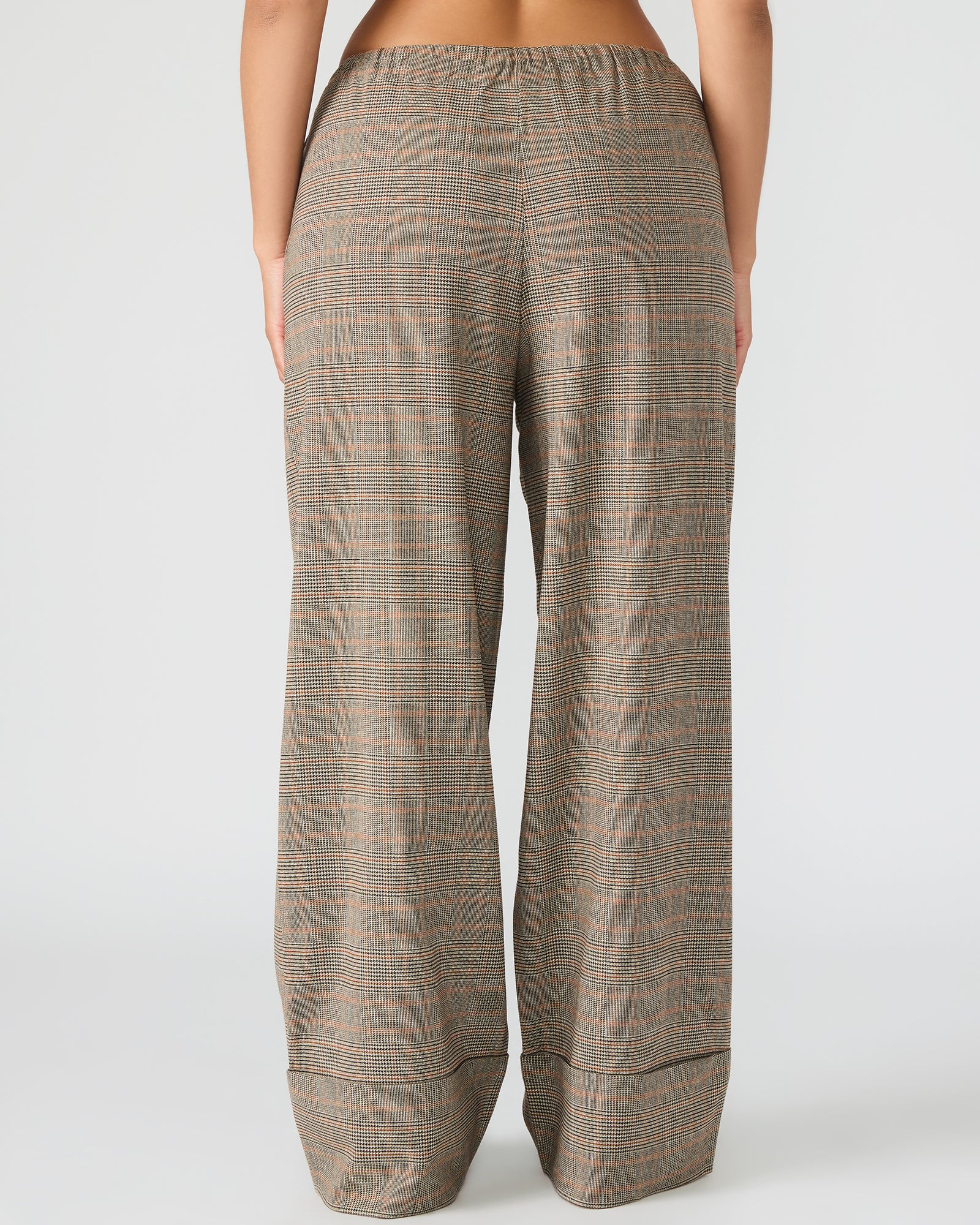 Women’s plaid pull-on pants with tie-front sitting stylishly on a chair