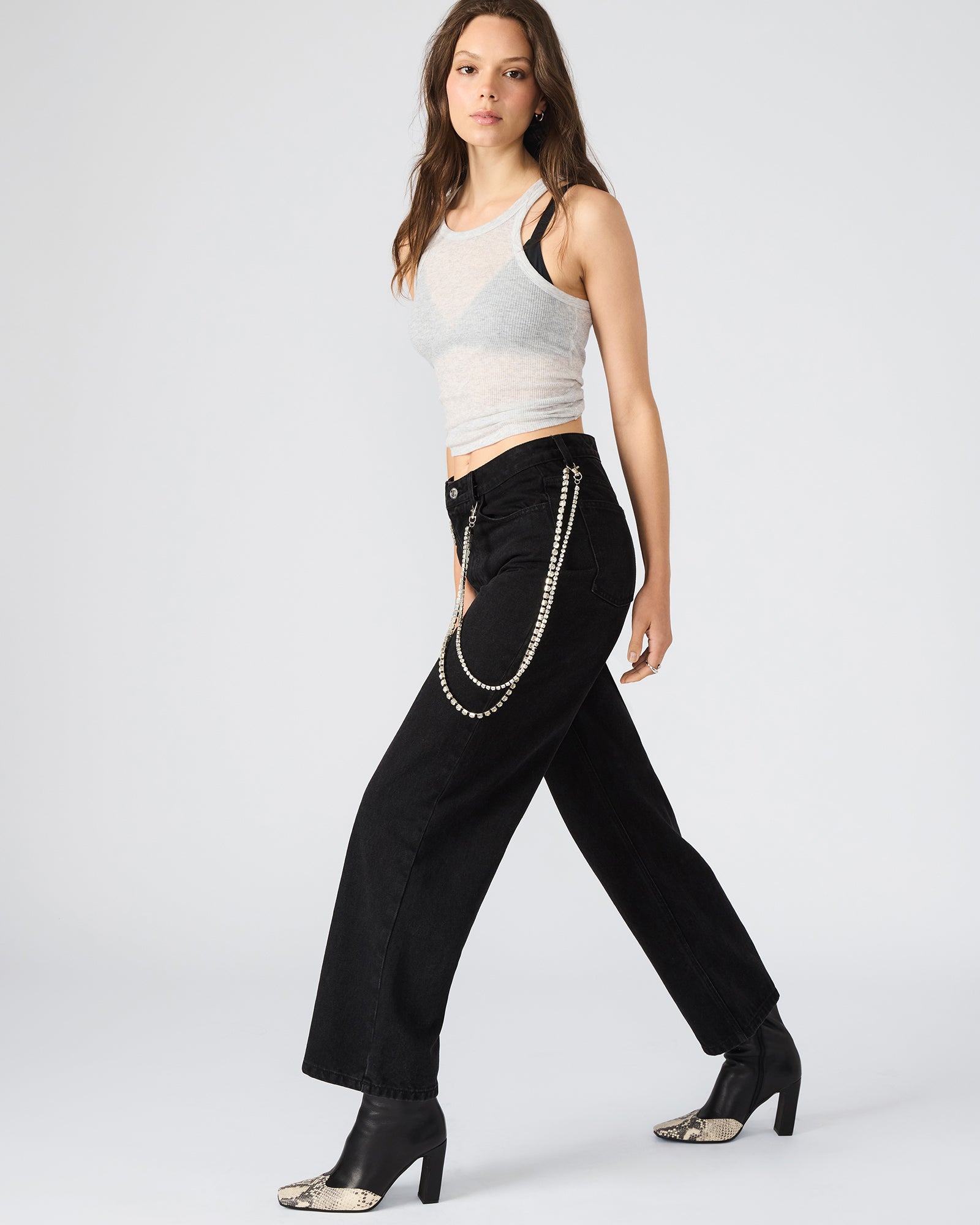 Side view of black wide-leg jeans, showcasing pockets and fit.