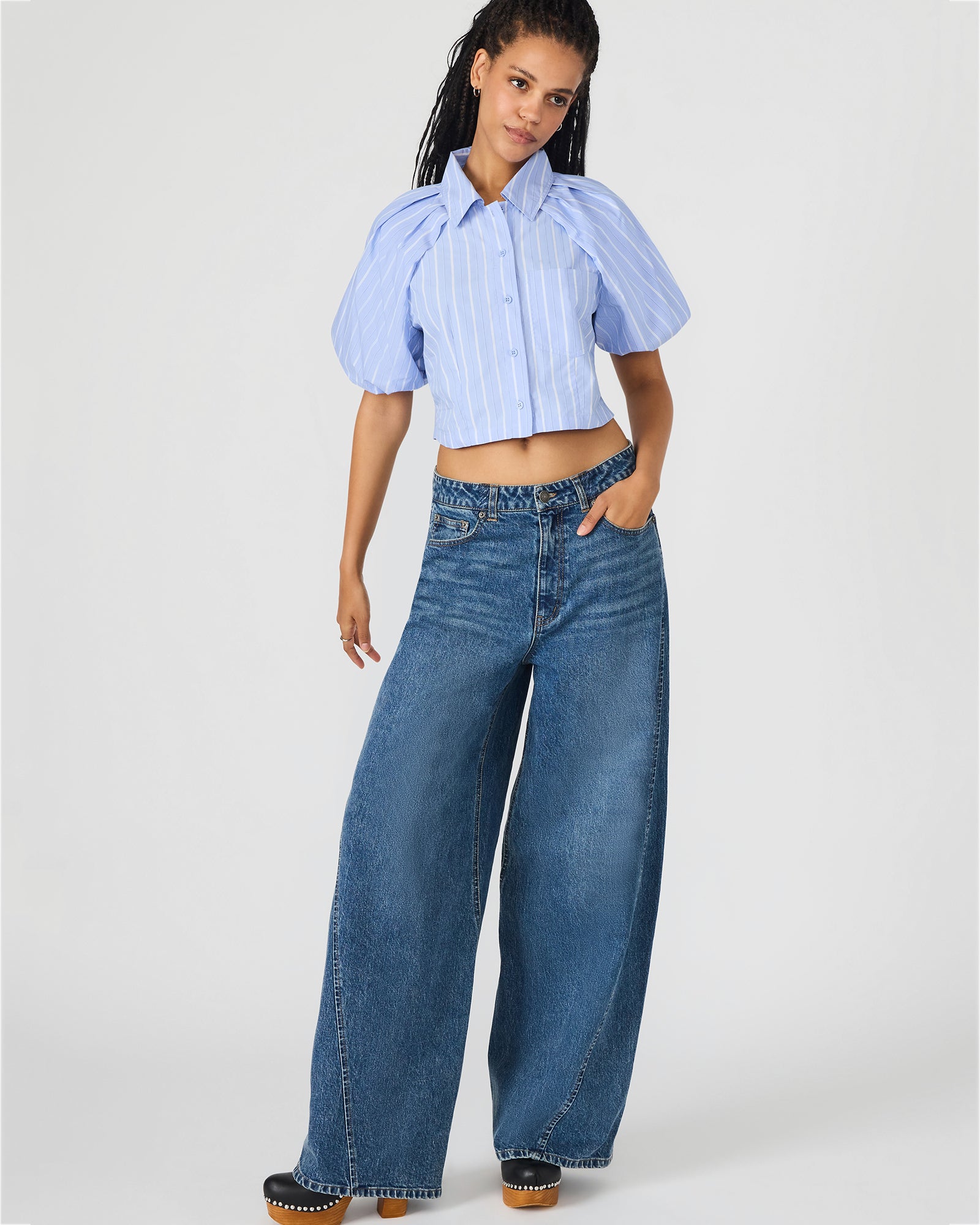 Side view of bubble sleeve top paired with stylish jeans