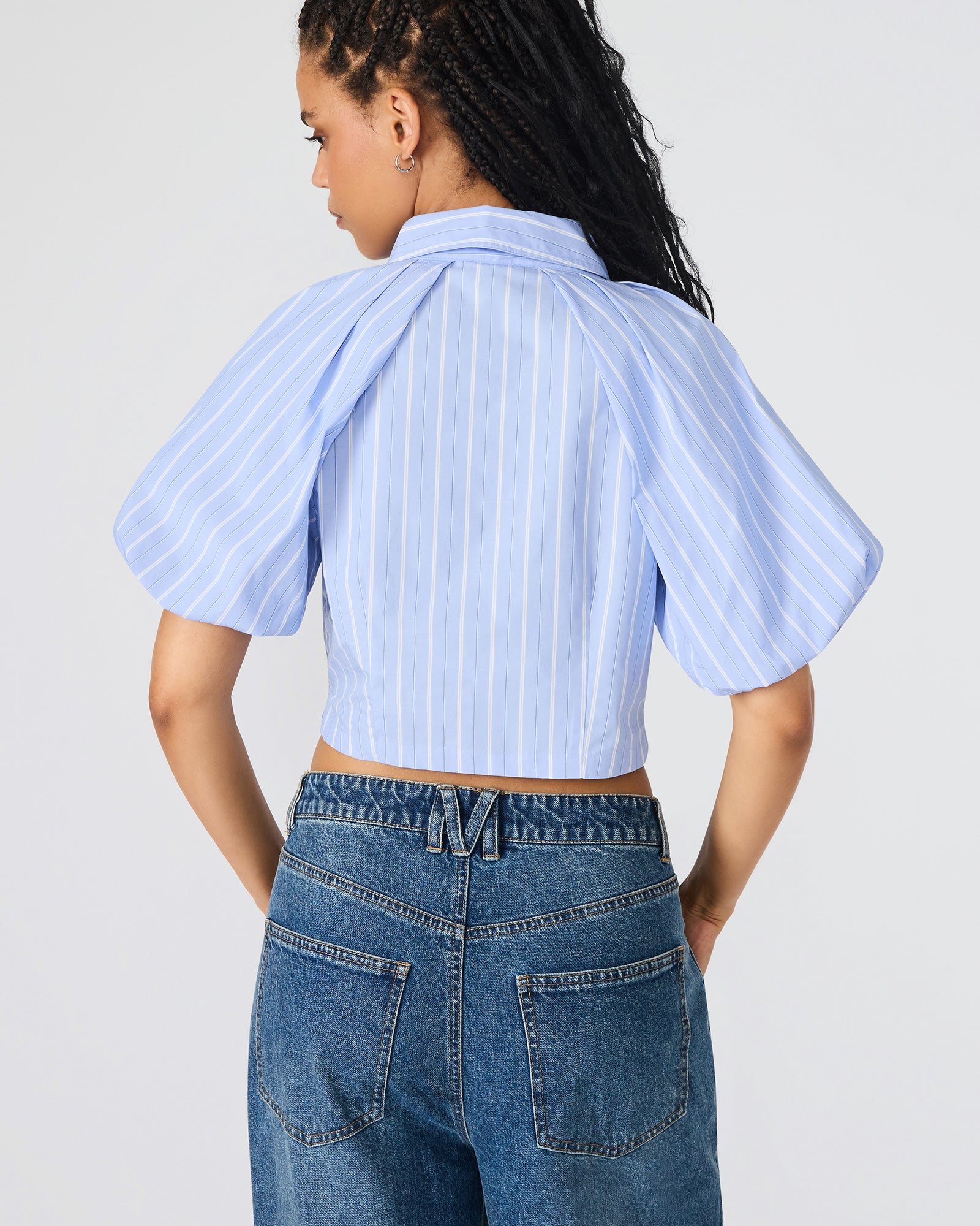 Front view of soft blue bubble sleeve crop top on model